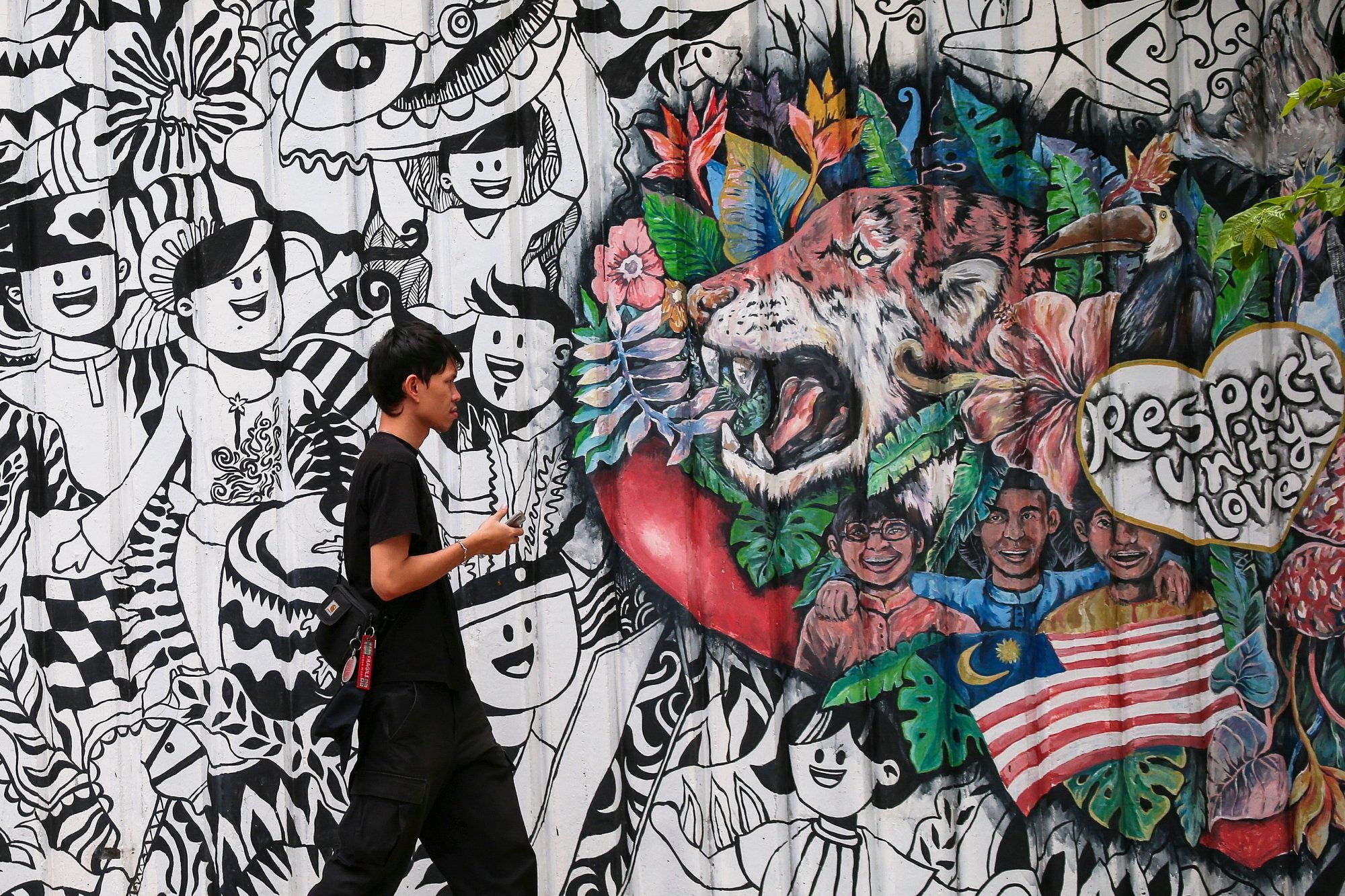 A tourist walks past a Malaysia decoration mural in Kuala Lumpur, Malaysia. Support for the ruling coalition has plummeted, according to Economy Minister Rafizi Ramli. Photo: EPA-EFE A tourist walks past a Malaysia decoration mural in Kuala Lumpur, Malaysia. Support for the ruling coalition has plummeted, according to Economy Minister Rafizi Ramli. Photo: EPA-EFE
