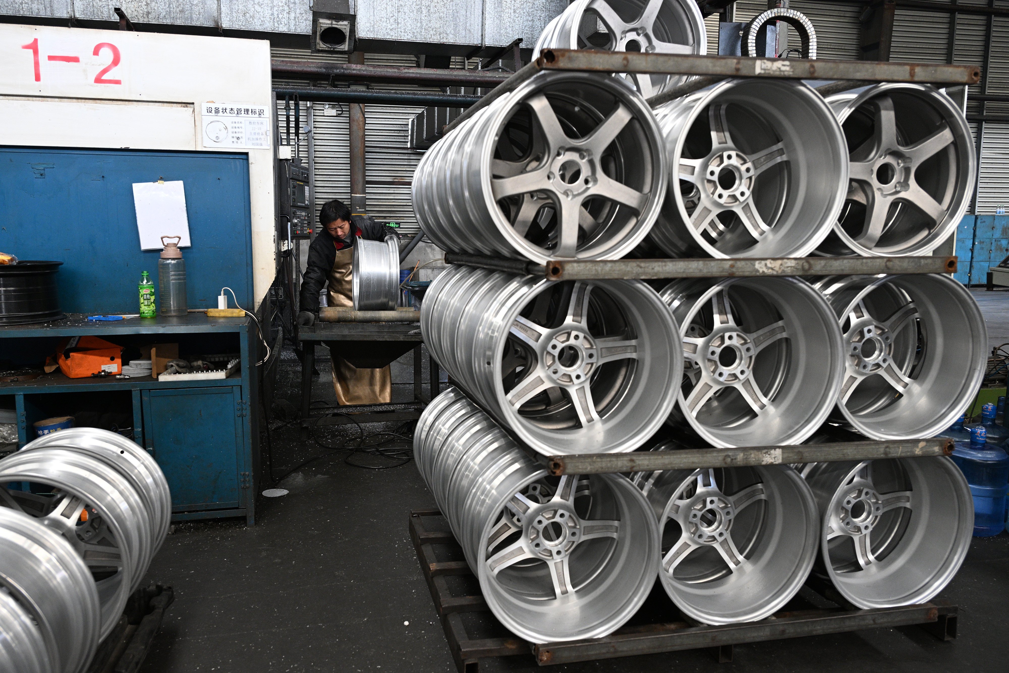 A worker puts finishing touches to wheels for exports at a factory in Suqian in Jiangsu province. Photo: Getty Images