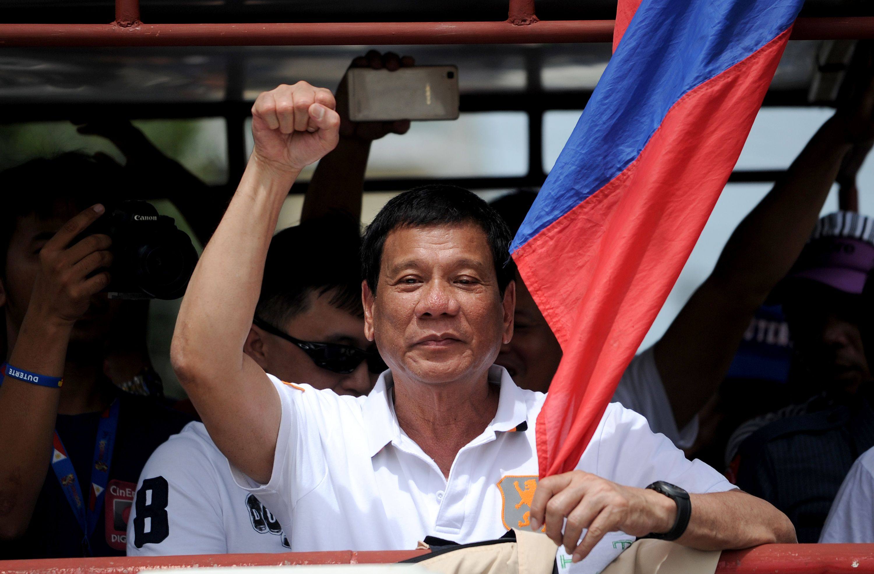 Then-Davao City mayor Duterte raises a clenched fist to supporters while campaigning for the Philippine presidency in 2016. Photo: AFP
