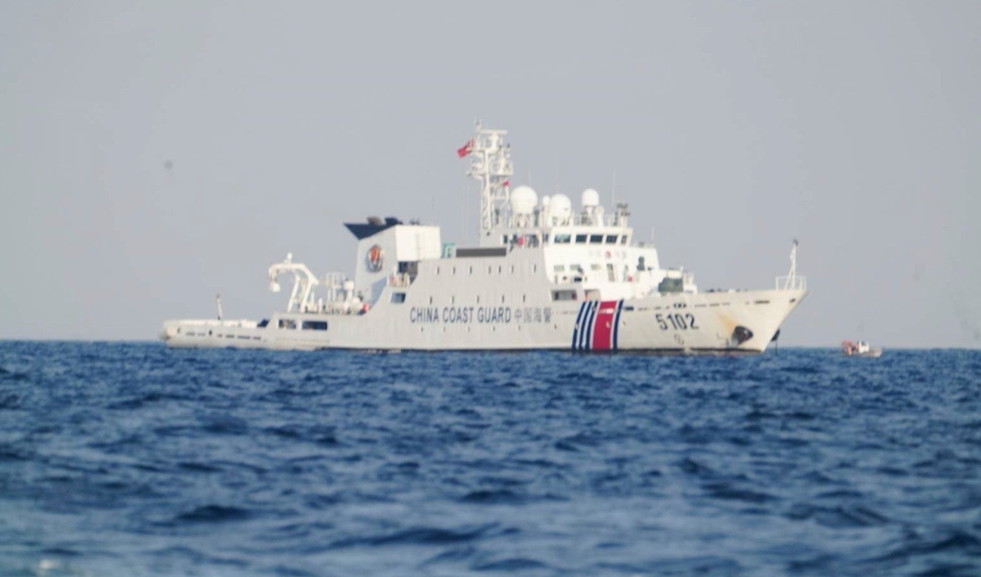 A China coastguard ship patrols as Philippine officials visit Sandy Cay 2 in the South China Sea on April 27. Photo: National Task Force West Philippine Sea / AP A China coastguard ship patrols as Philippine officials visit Sandy Cay 2 in the South China Sea on April 27. Photo: National Task Force West Philippine Sea / AP
