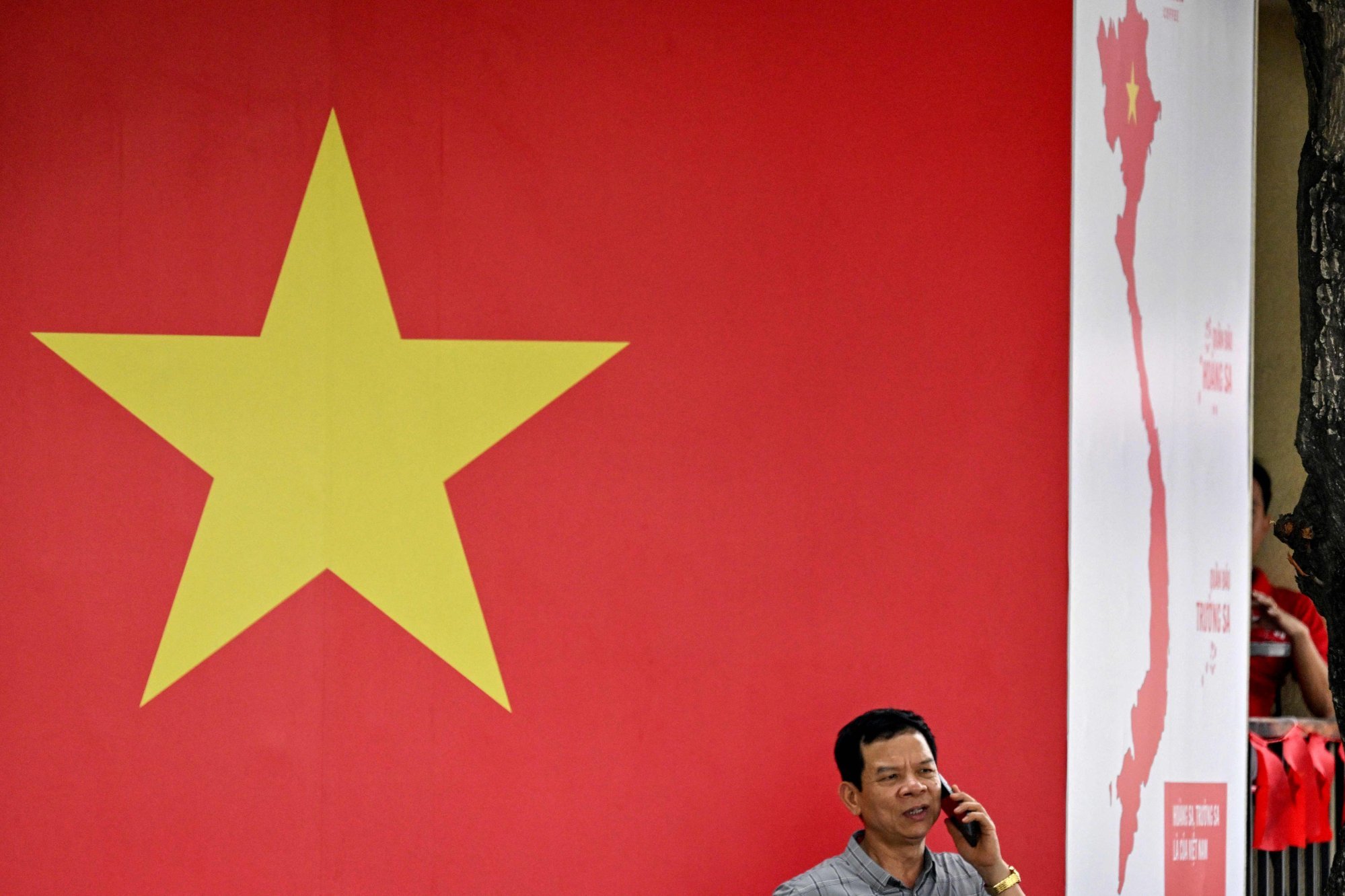 A man uses his phone in Ho Chi Minh City. Vietnam is requiring foreign social media platforms to verify their users’ accounts and provide authorities with their identities on demand. Photo: AFP A man uses his phone in Ho Chi Minh City. Vietnam is requiring foreign social media platforms to verify their users’ accounts and provide authorities with their identities on demand. Photo: AFP