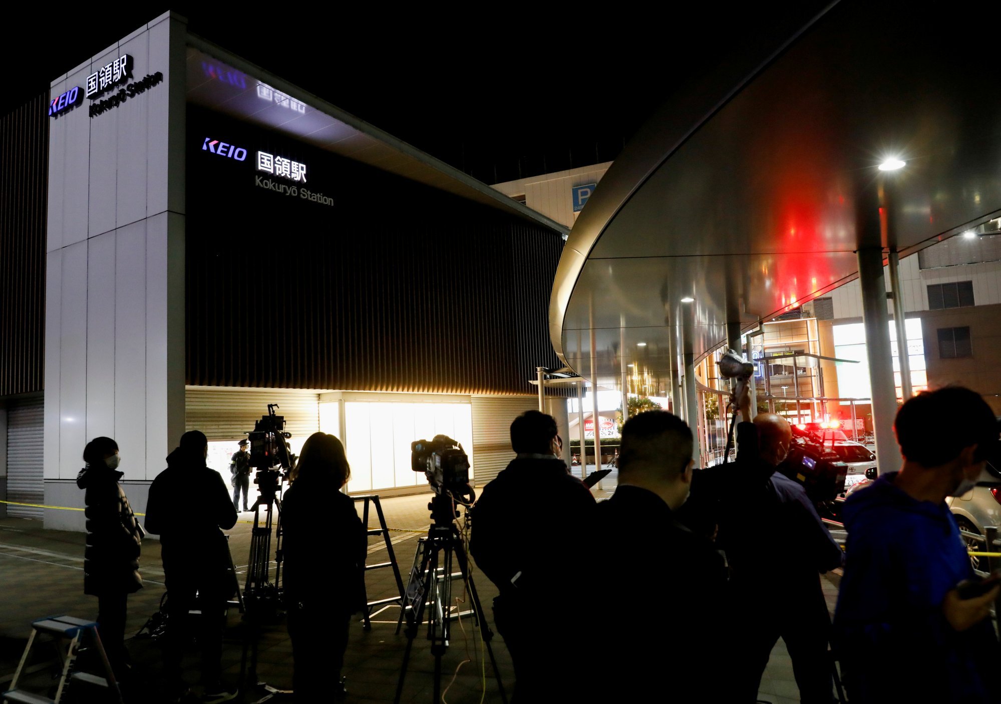 Reporters outside the Kokuryo station in Tokyo after a knife, arson and acid attack occurred on a train on November 1, 2021. Photo: Reuters Reporters outside the Kokuryo station in Tokyo after a knife, arson and acid attack occurred on a train on November 1, 2021. Photo: Reuters