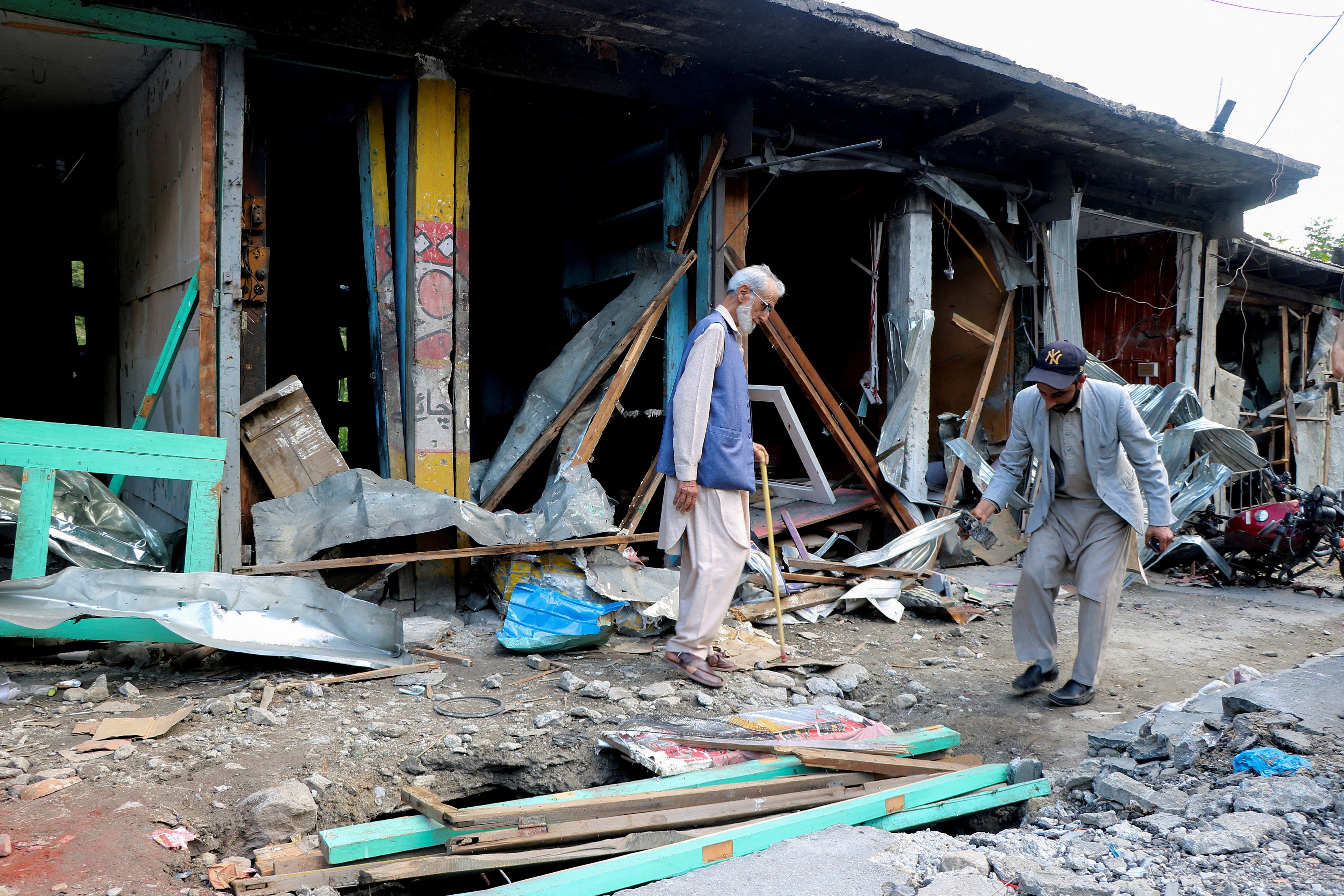 Shopkeepers in Neelum Valley, Pakistani Kashmir, assess the damage on Monday after an Indian air strike. Photo: Reuters