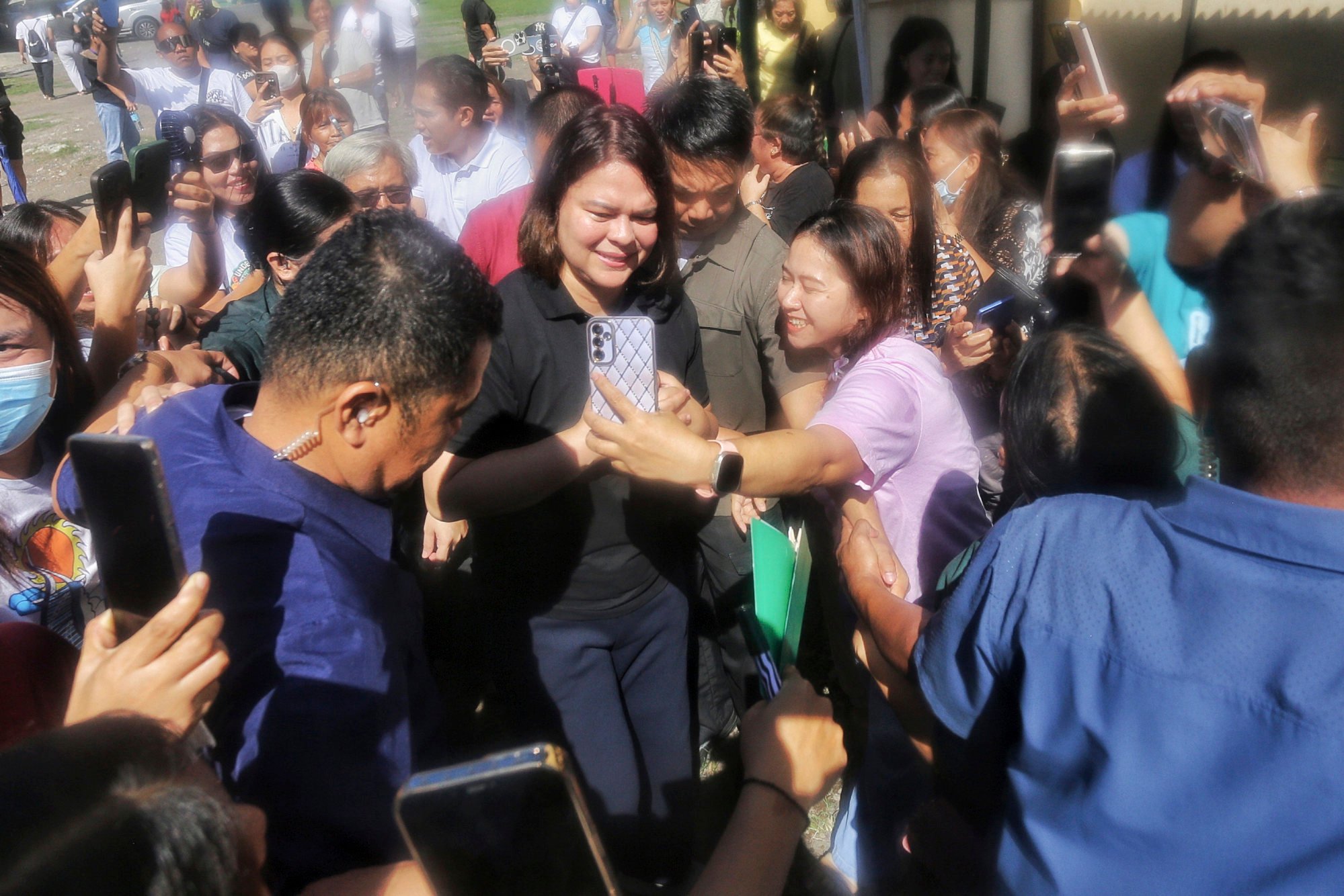 Philippine Vice-President Sara Duterte-Carpio (centre) greets supporters as she arrives to cast her vote at a polling centre in Davao City, southern Philippines, on Monday. Photo: AP Philippine Vice-President Sara Duterte-Carpio (centre) greets supporters as she arrives to cast her vote at a polling centre in Davao City, southern Philippines, on Monday. Photo: AP
