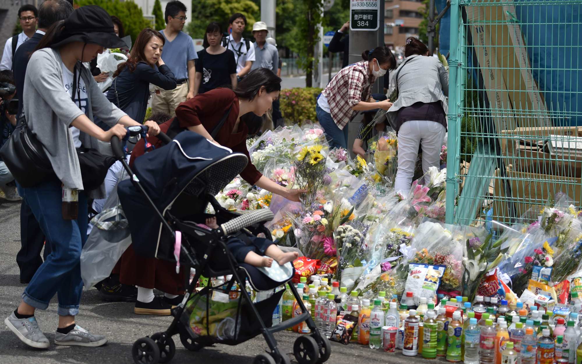 People offering flowers at the crime scene where Ryuichi Iwasaki, 51, killed two persons and injured 18 others in Kawasaki in 2019. Photo: AFP People offering flowers at the crime scene where Ryuichi Iwasaki, 51, killed two persons and injured 18 others in Kawasaki in 2019. Photo: AFP