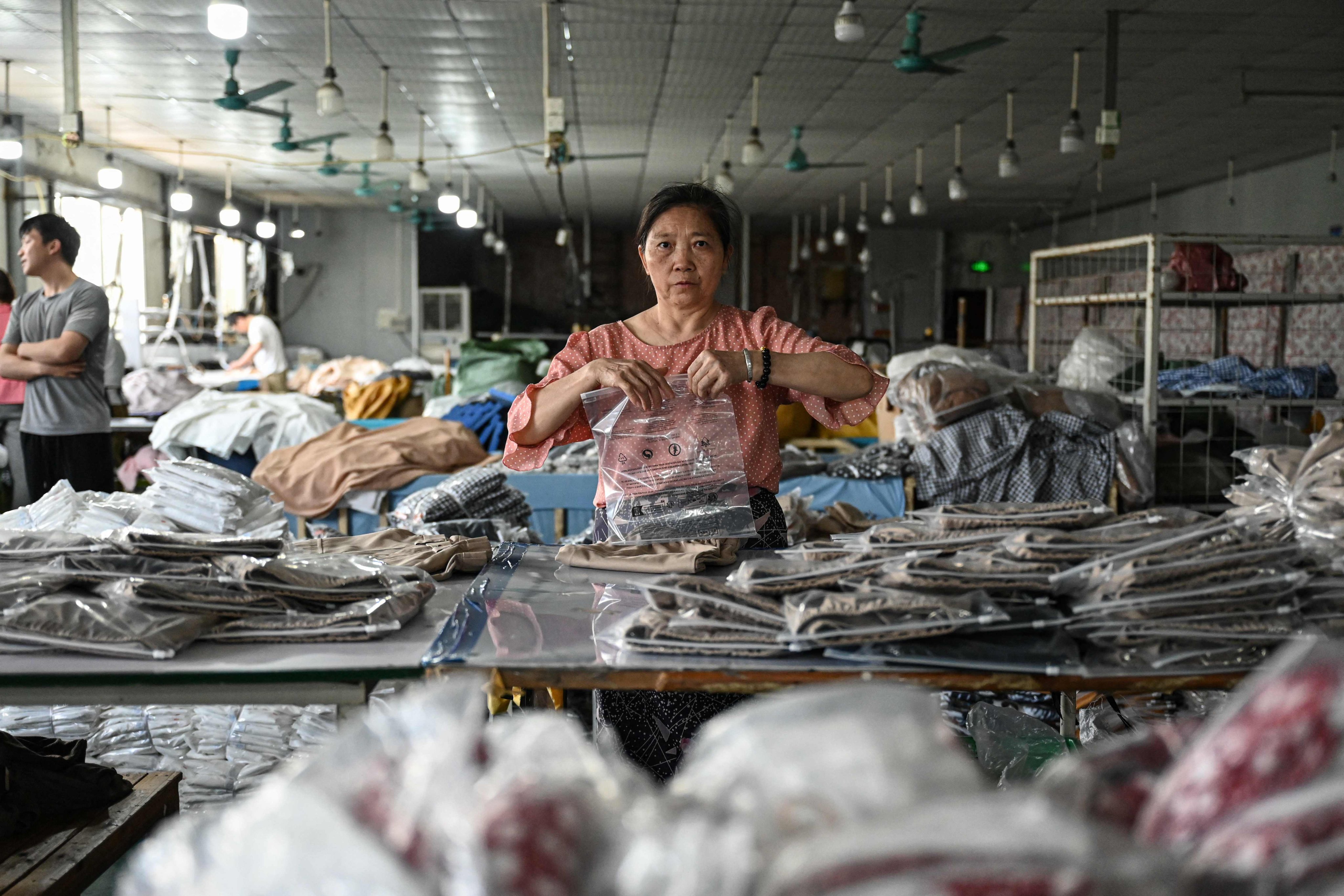 A worker packages products inside an apparel factory in China. Chinese producers are rushing to front-load shipments following the announcement of a 90-day truce in the US-China trade war. Photo: AFP