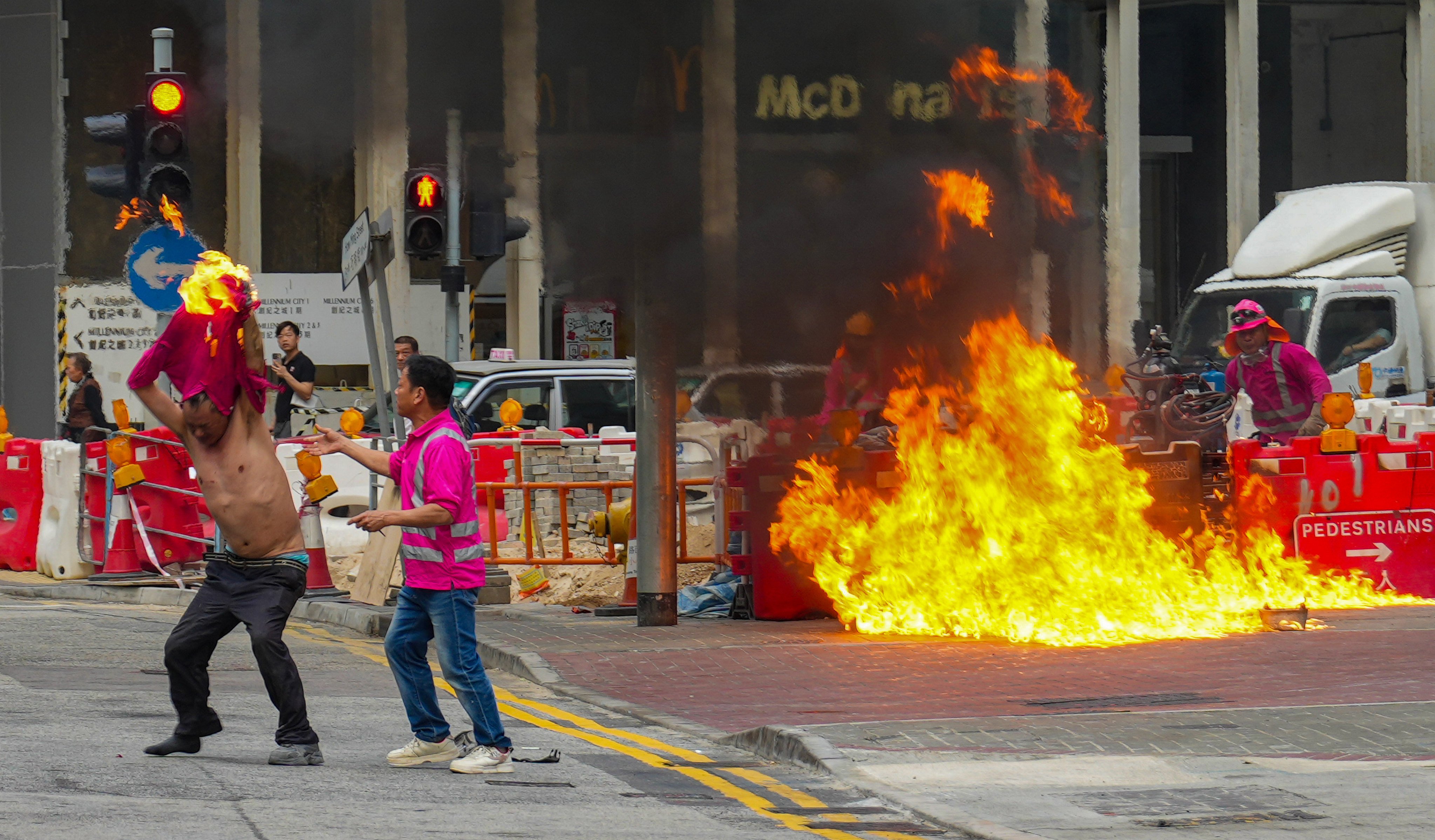 Sam Tsang’s shot of a construction worker’s clothing catching fire after an accident in Kwun Tong won the Breaking News category. Photo: Sam Tsang
