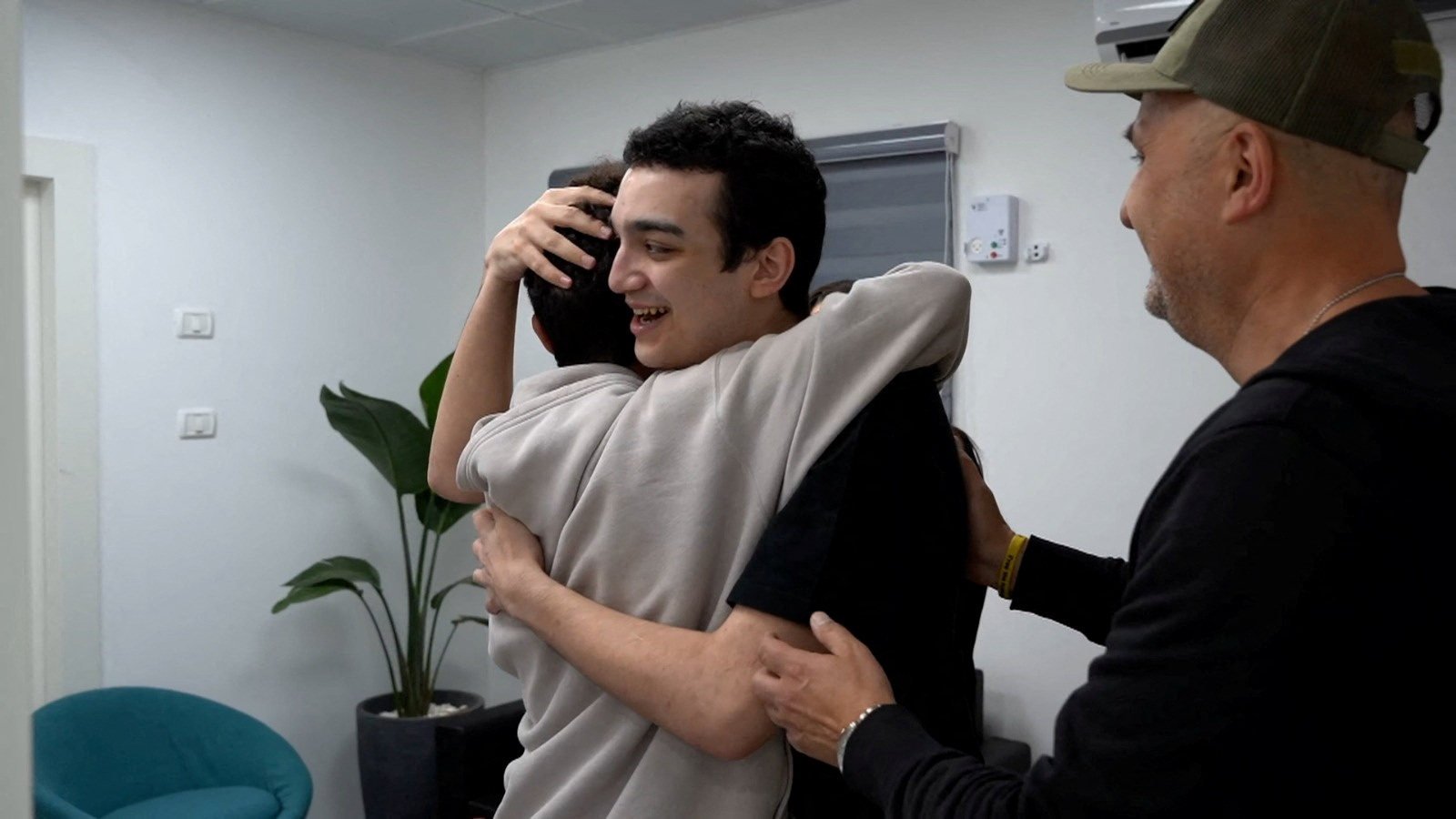 Released US-Israeli hostage Edan Alexander embraces his brother as he reunites with his family in Reim, southern Israel, before flying to Tel Aviv on Monday. Photo: GPO / Handout via Reuters