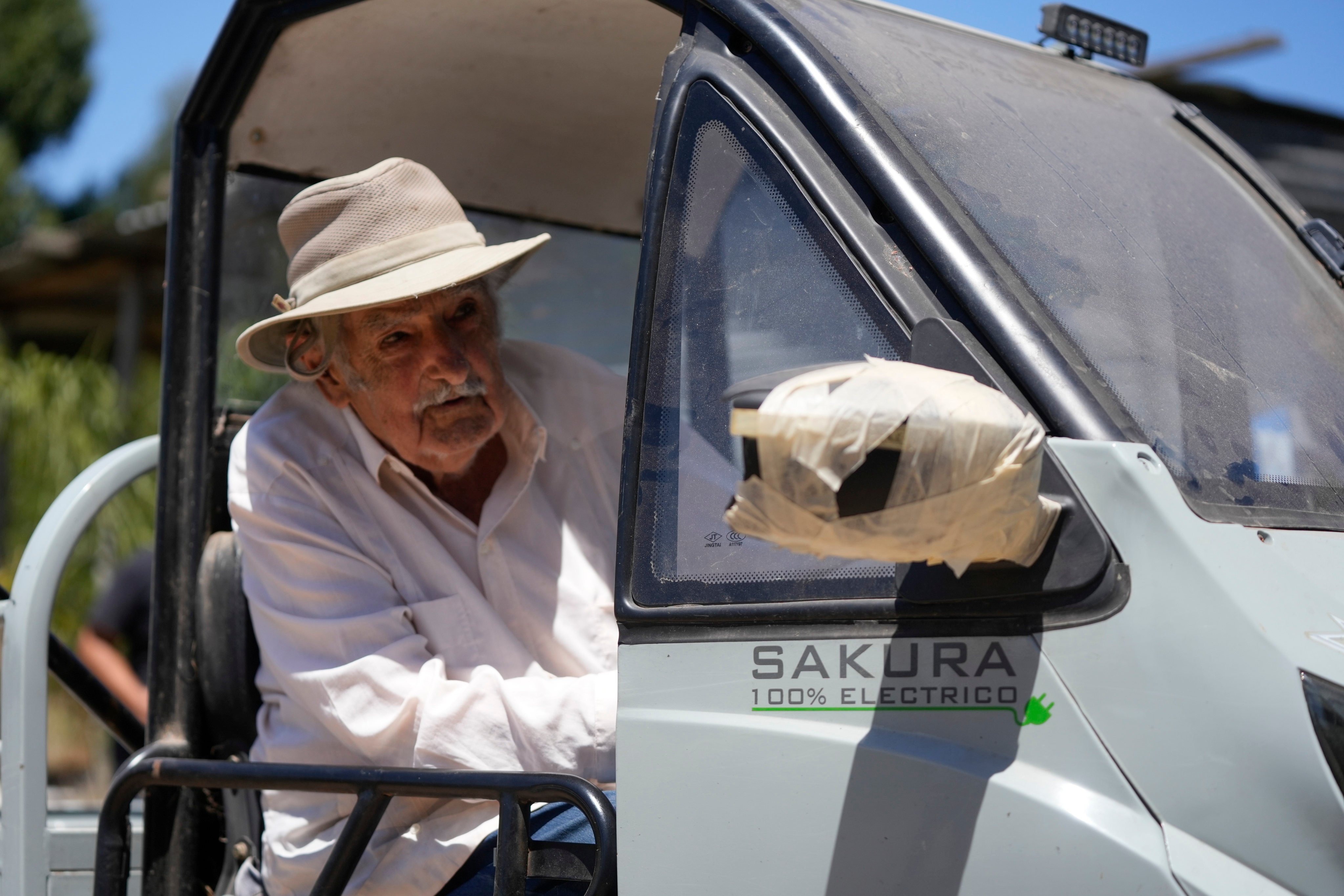 Jose Mujica drives an electric vehicle at his farm in Montevideo, Uruguay, in February. Photo: Xinhua