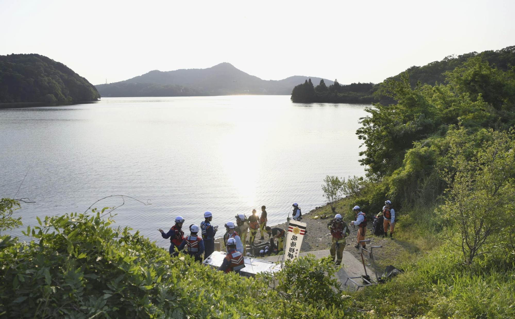 Firefighters gather in Inuyama, central Japan, for a search operation as a Japanese air force plane crashed after taking off for a training flight. Photo: via AP Firefighters gather in Inuyama, central Japan, for a search operation as a Japanese air force plane crashed after taking off for a training flight. Photo: via AP