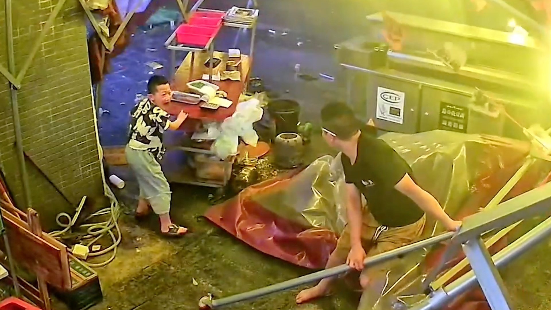 Chinese boy holds food counter as strong winds hit parents’ restaurant