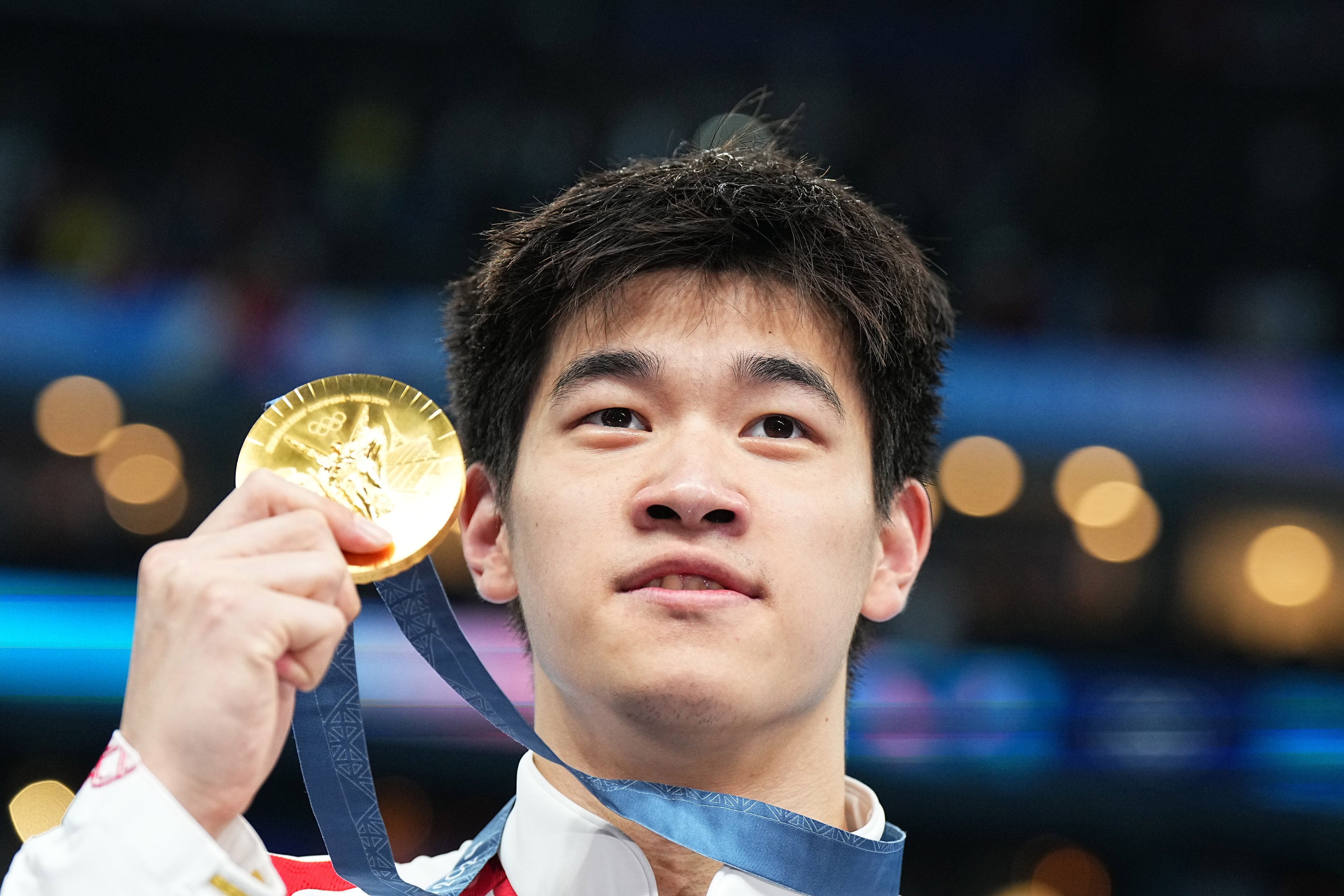 China’s Pan Zhanle clutches his Olympic 100m freestyle gold medal at the Paris La Defence Arena last July. Photo: dpa