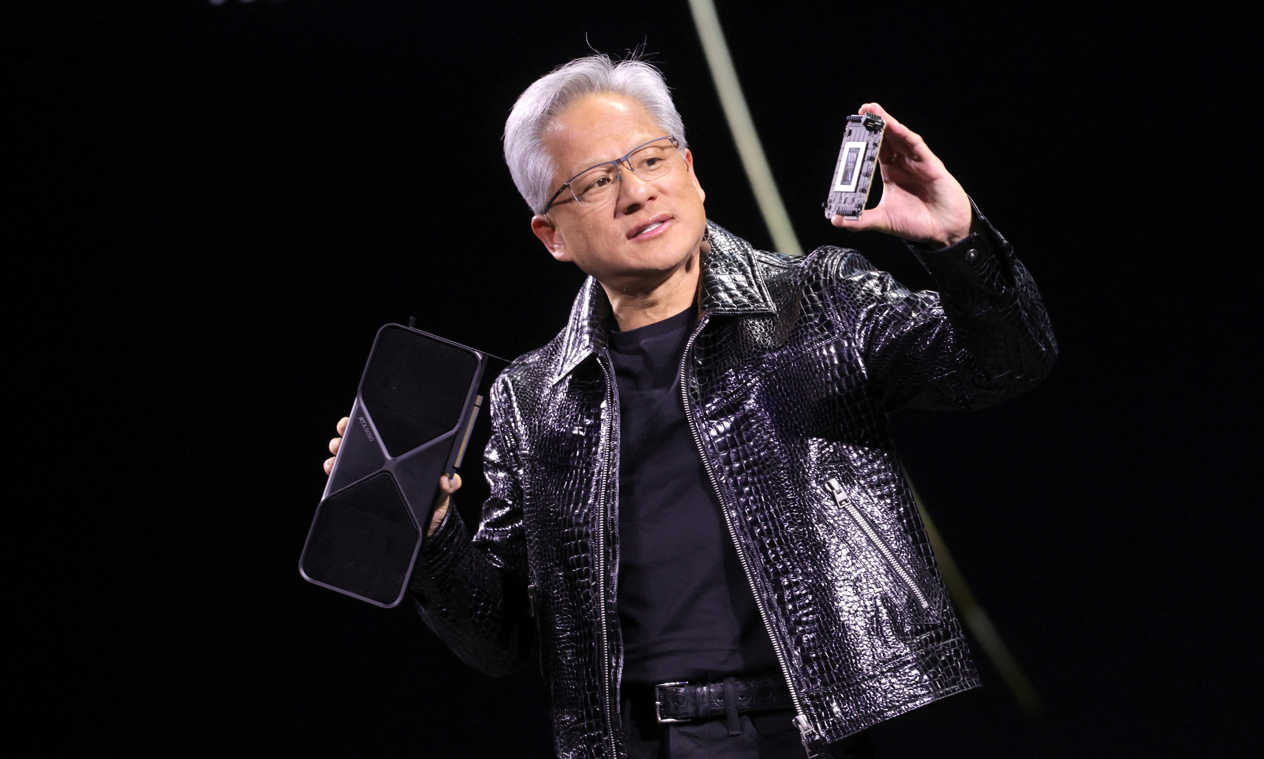 Nvidia CEO Jensen Huang holds up the company’s RTX 5090 graphics card, during a keynote address at CES 2025 in Las Vegas, January 6, 2025. Photo: Reuters