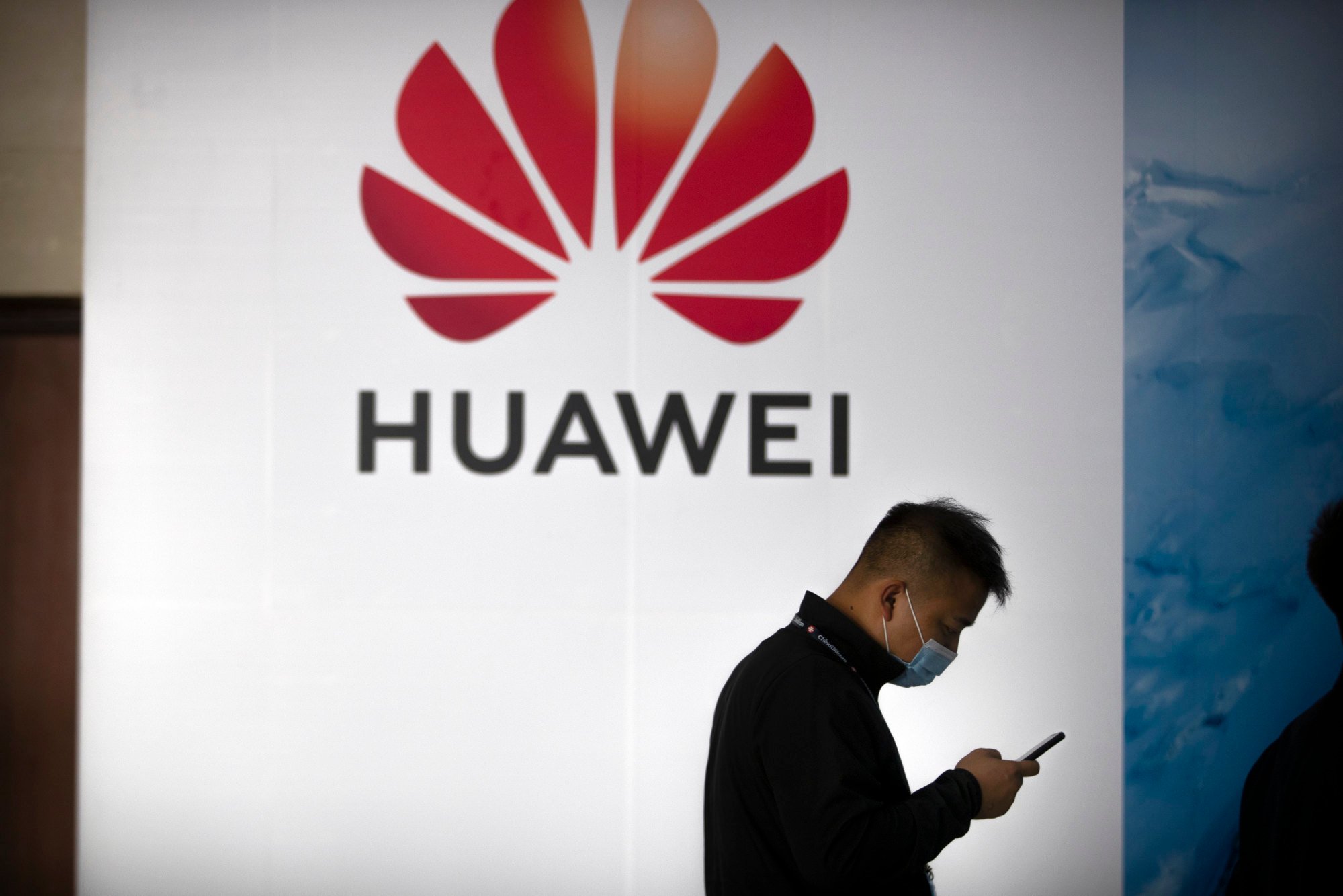 A man walks past a sign advertising Huawei in Beijing in 2020. Southeast Asia’s reliance on Chinese tech like Huawei offers economic growth but raises cybersecurity and geopolitical concerns amid US-China tensions. Photo: AP
