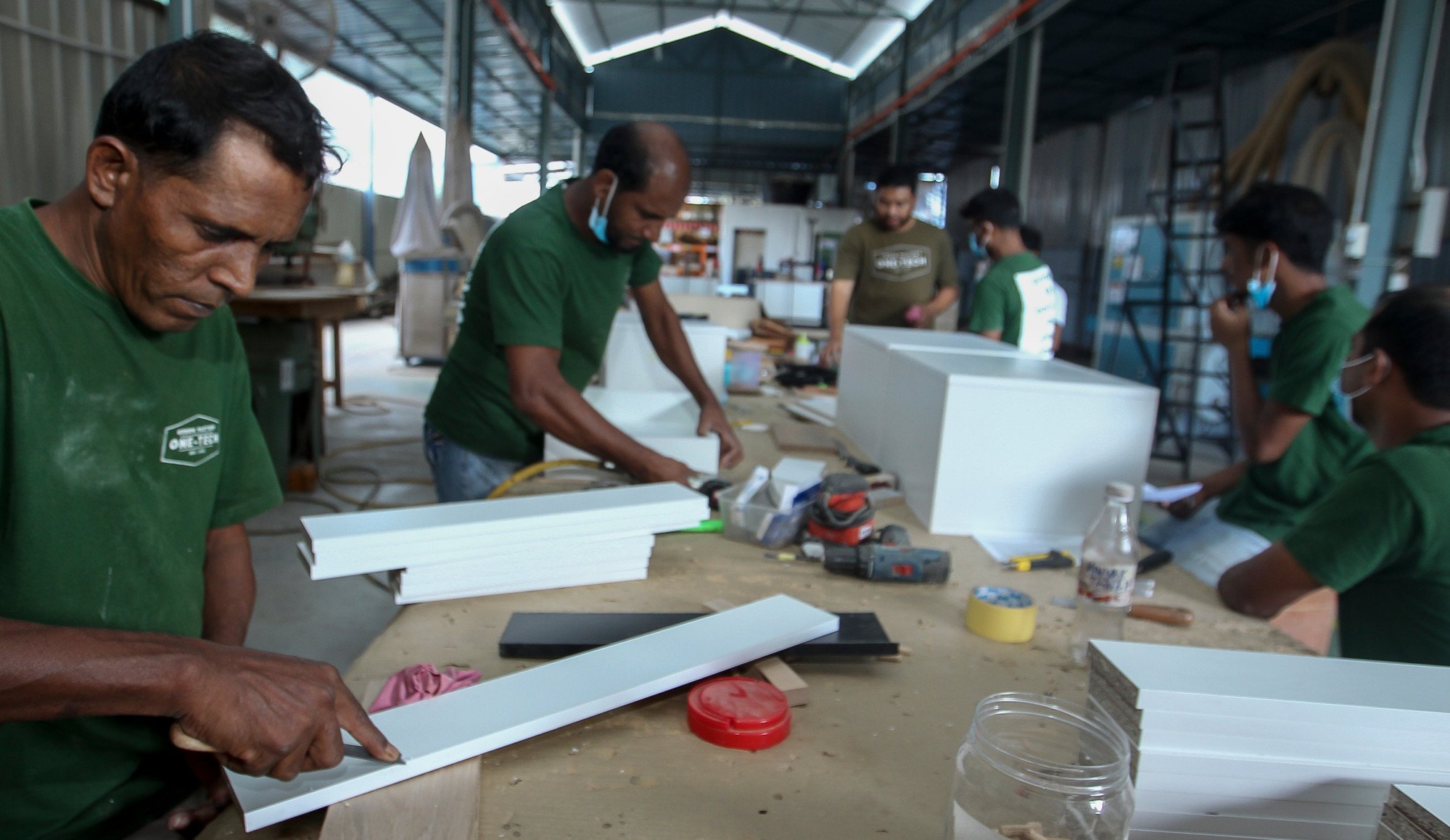 Migrant workers from Bangladesh working in a timber and furniture factory in Malaysia. Photo: Shutterstock