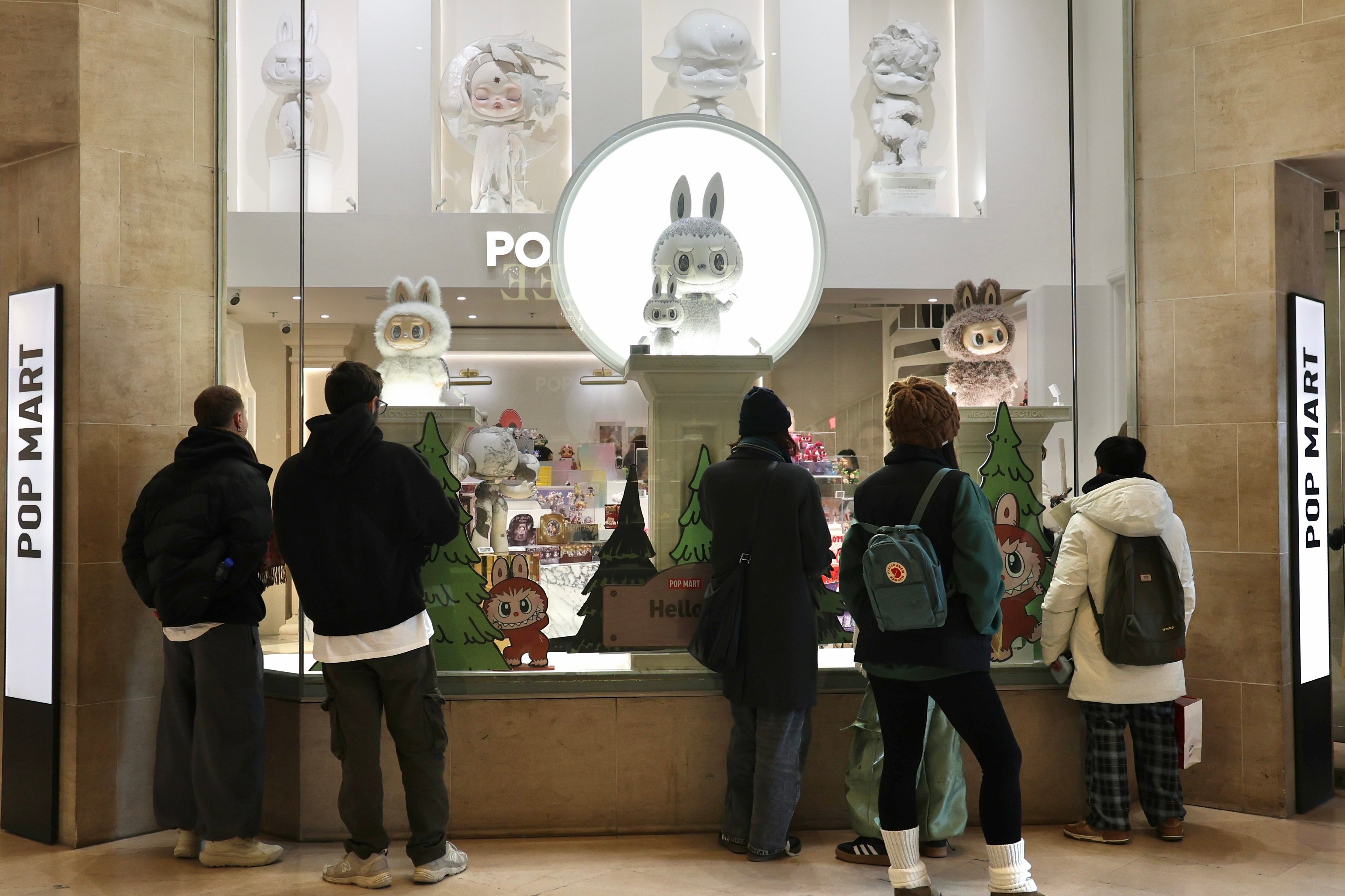 Shoppers look through the window of a Pop Mart store near the Louvre Museum in Paris. The Chinese toy giant has attracted a devoted fan base in Europe with its Labubu and Crybaby collectible dolls. Photo: Xinhua