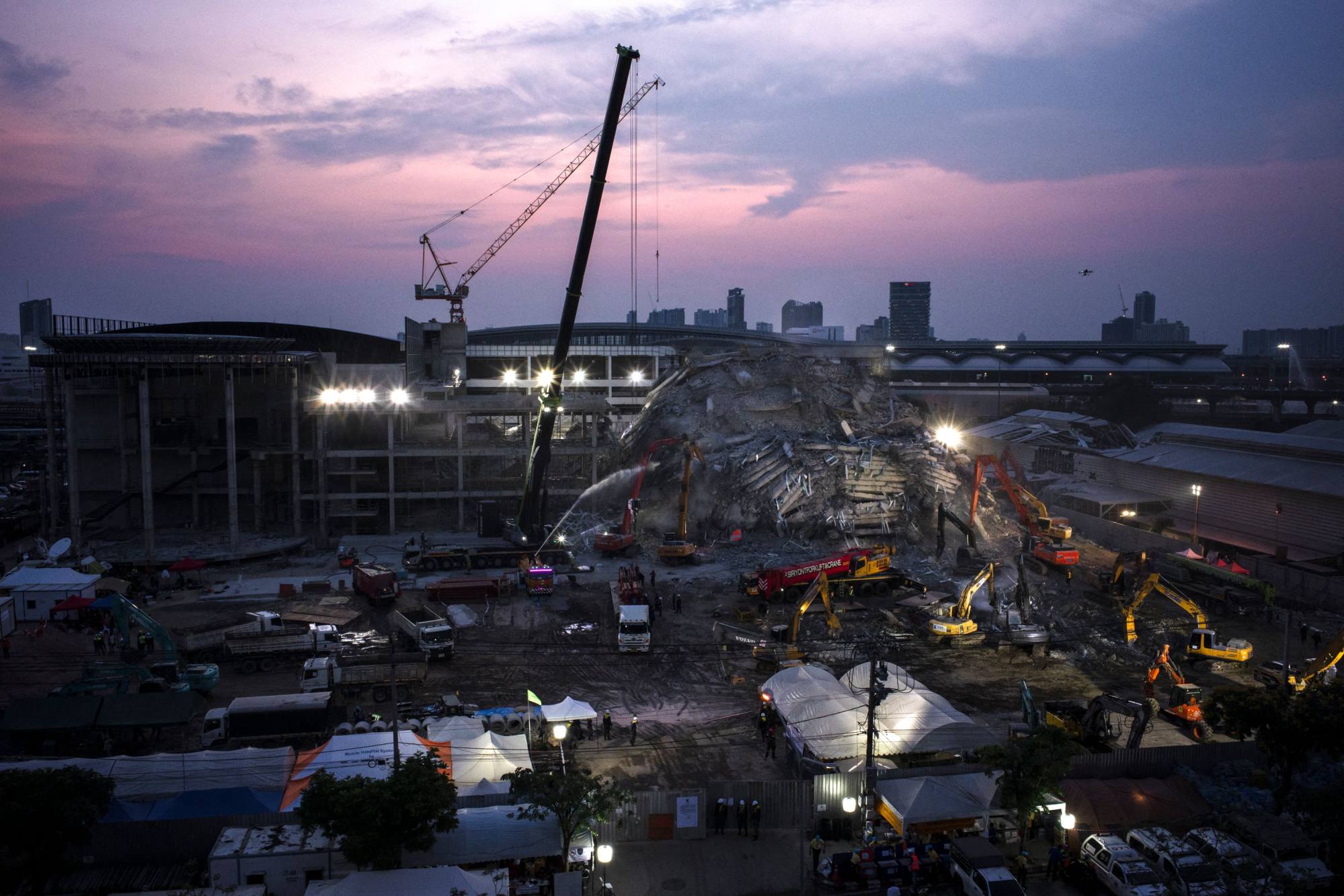 The sun sets over the site of an under-construction building collapse in Bangkok on April 2, 2025, five days after an earthquake struck central Myanmar and Thailand. Photo: Agence France-Presse The sun sets over the site of an under-construction building collapse in Bangkok on April 2, 2025, five days after an earthquake struck central Myanmar and Thailand. Photo: Agence France-Presse