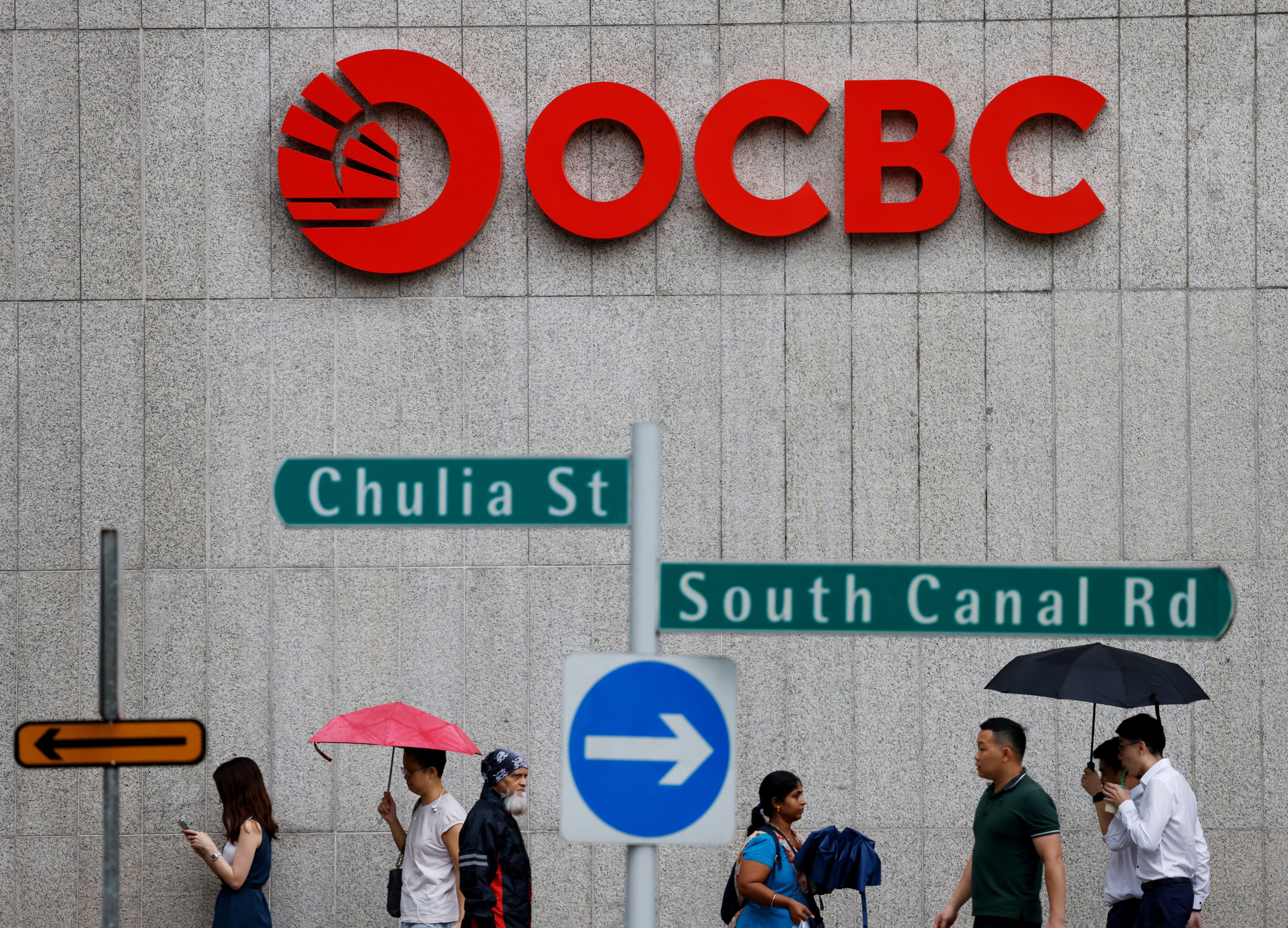 People pass an OCBC bank signage in Singapore. Photo: Reuters