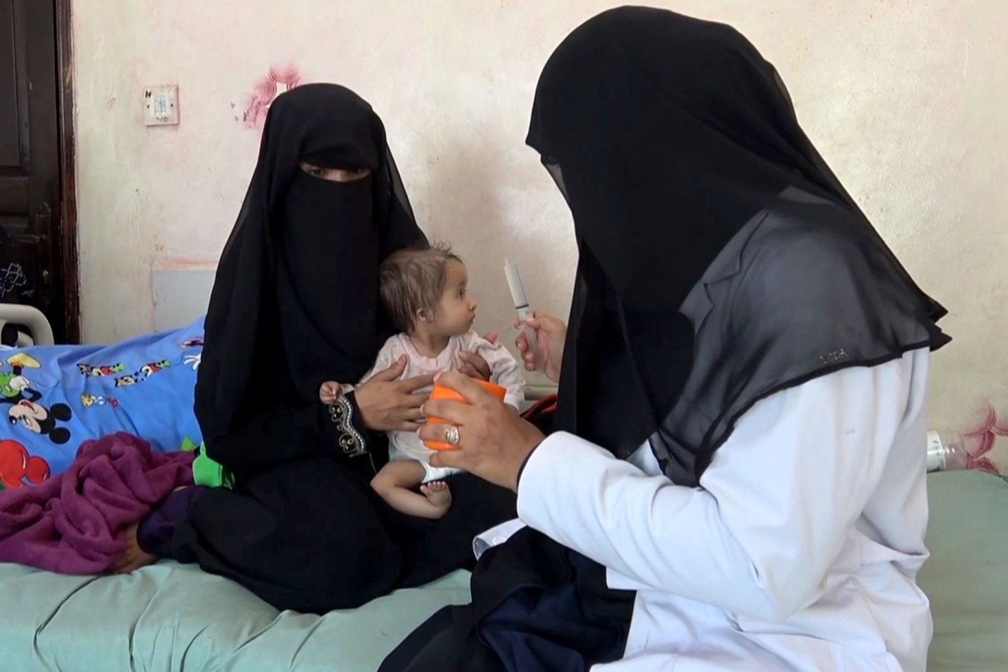 A Yemeni mother holds her malnourished child as a nurse tries to feed the baby, in 2018. Photo: AFP A Yemeni mother holds her malnourished child as a nurse tries to feed the baby, in 2018. Photo: AFP