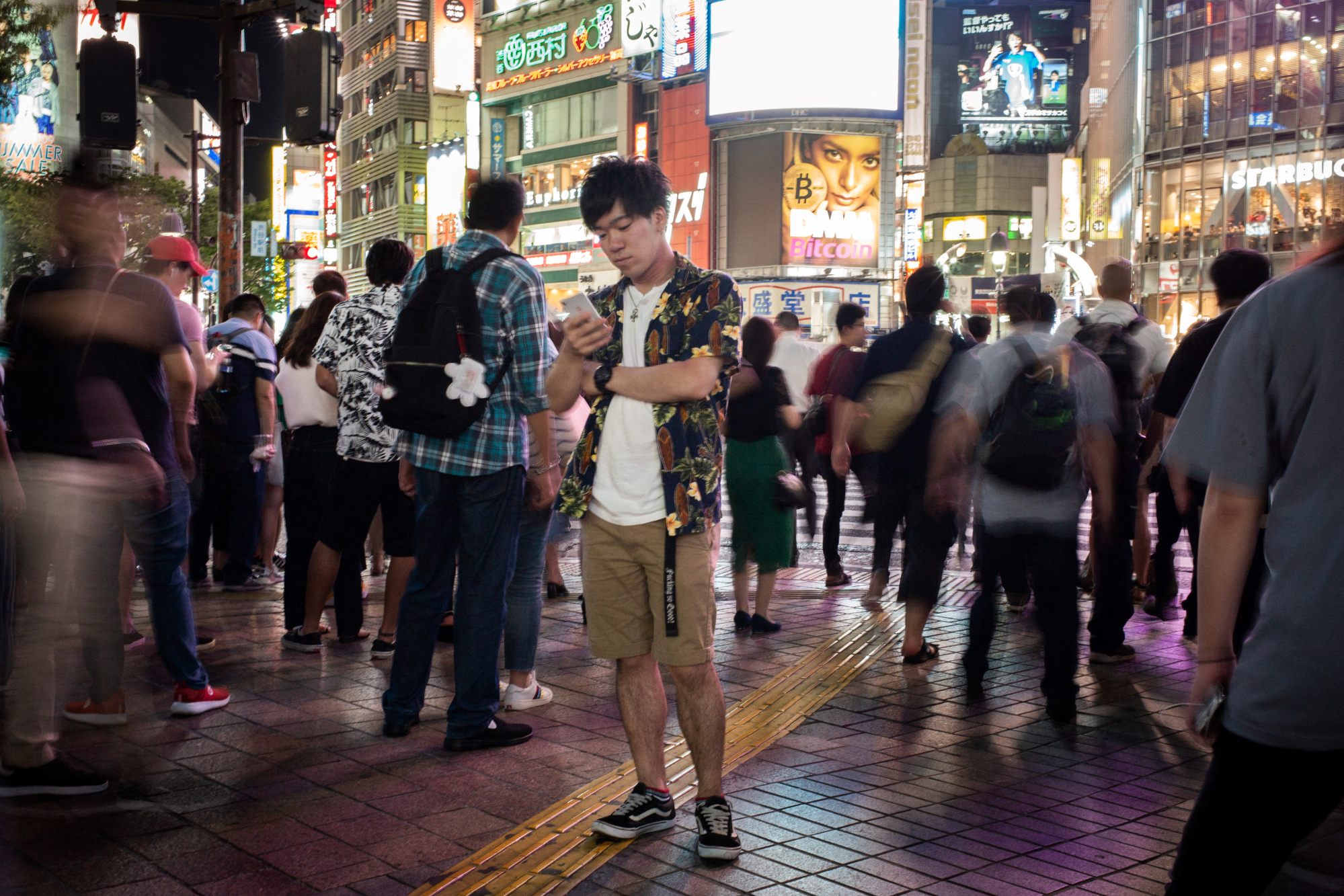 A man looks at his phone in Shibuya, Tokyo. Photo: AFP A man looks at his phone in Shibuya, Tokyo. Photo: AFP