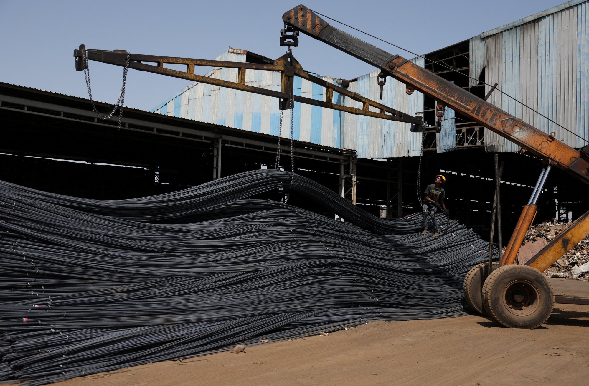 A labourer unloads steel bars inside a manufacturing facility at Viramgam in the Indian state of Gujarat last month. Photo: Reuters A labourer unloads steel bars inside a manufacturing facility at Viramgam in the Indian state of Gujarat last month. Photo: Reuters
