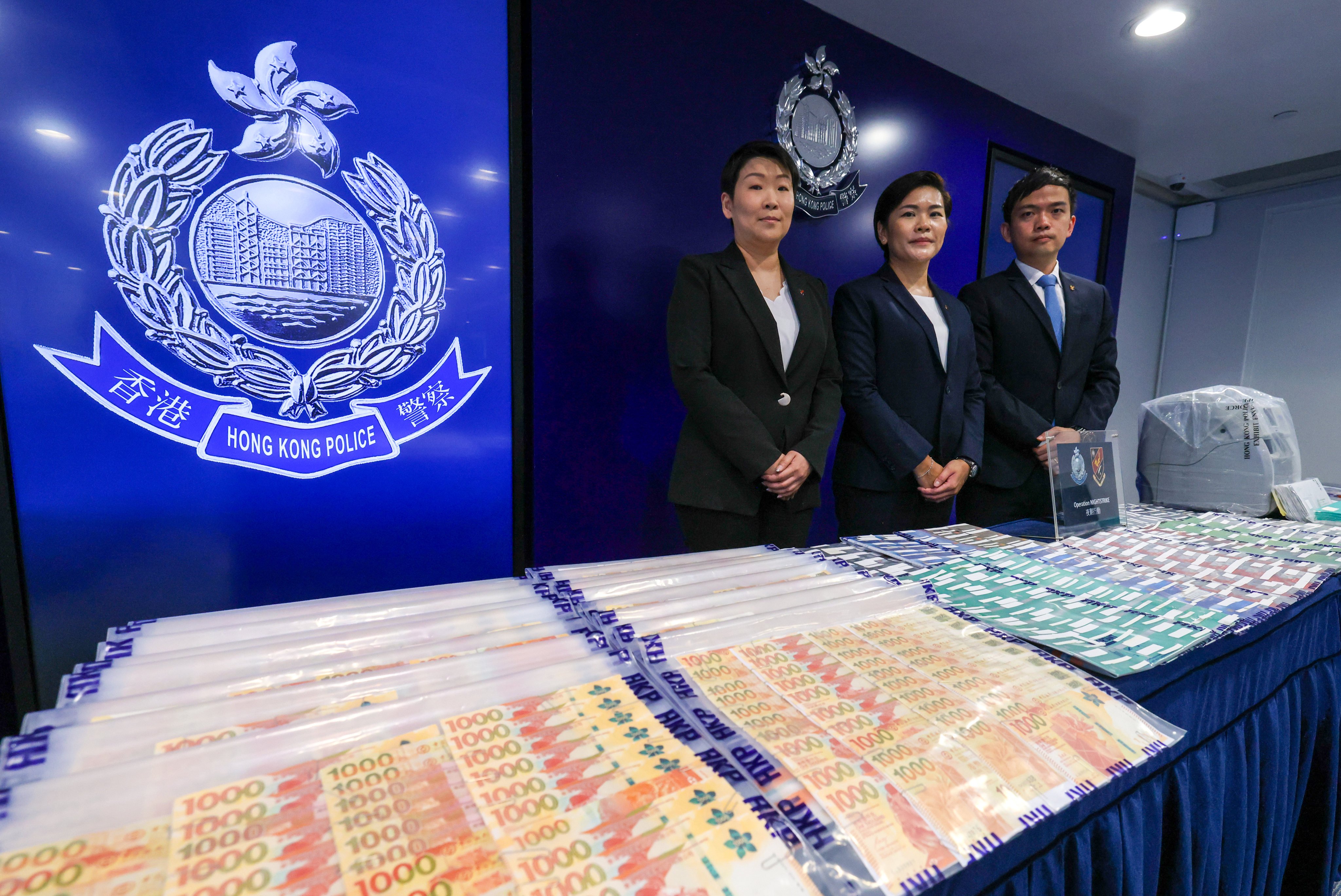 (From left) Chief Inspector Lo Yuen-shan, Superintendent Kwok Ching-yee and Senior Inspector Tse Ka-lun pose with items seized during an operation on Thursday. Photo: Nora Tam