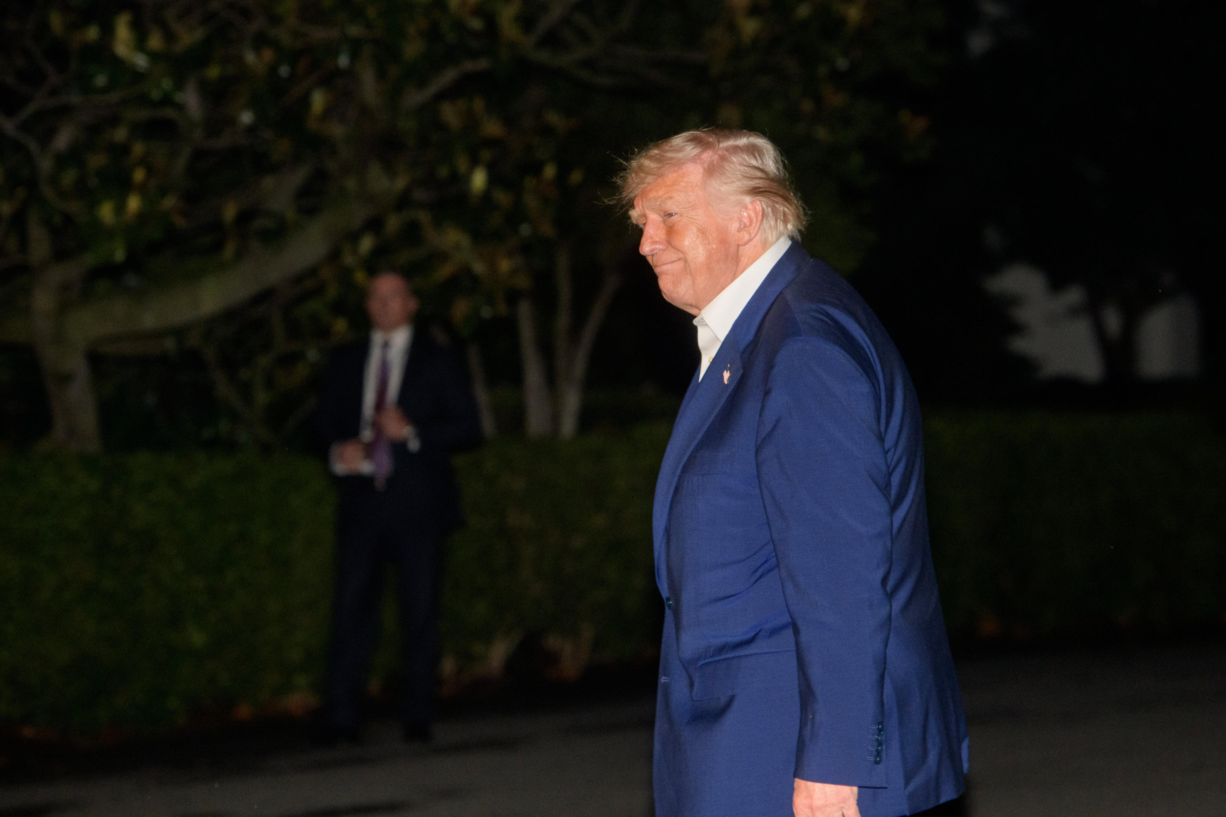 US President Donald Trump walks across the South Lawn upon arrival at the White House on Friday. Photo: AP