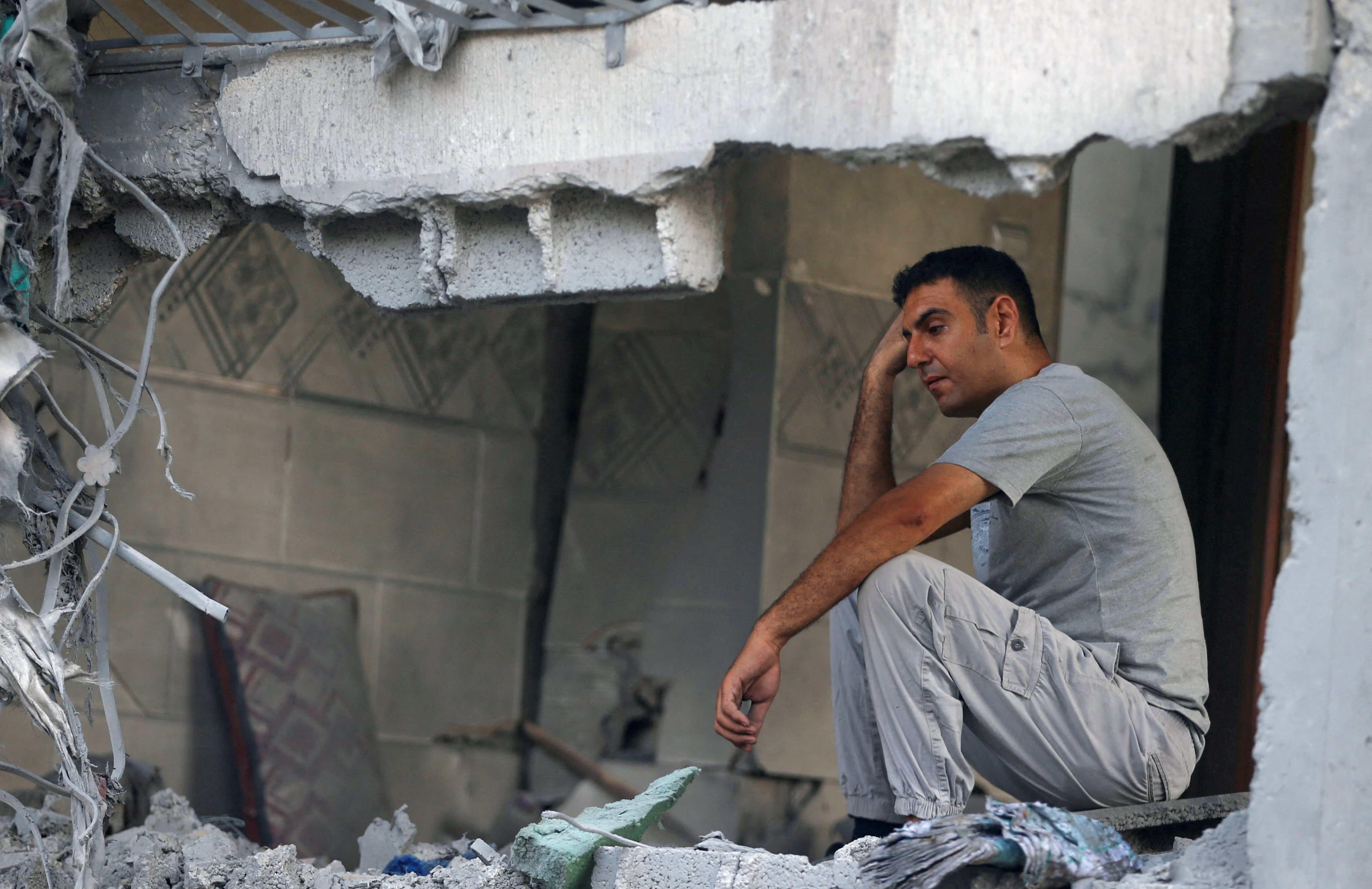 A Palestinian man sits among the remnants of a house in Jabalia, in north Gaza, on Sunday. Photo: Reuters