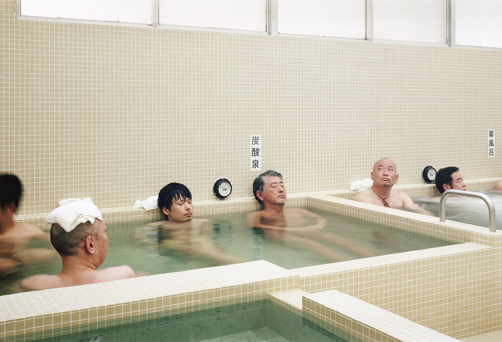 Men bathing in Koganeyu, a sento, or traditional public bathhouse, in Tokyo. Visitors to Japan can go “sento running”  – have a run from a bathhouse and return for a bath or shower, and sauna. Some rent out running gear. Photo: Yurika Kono