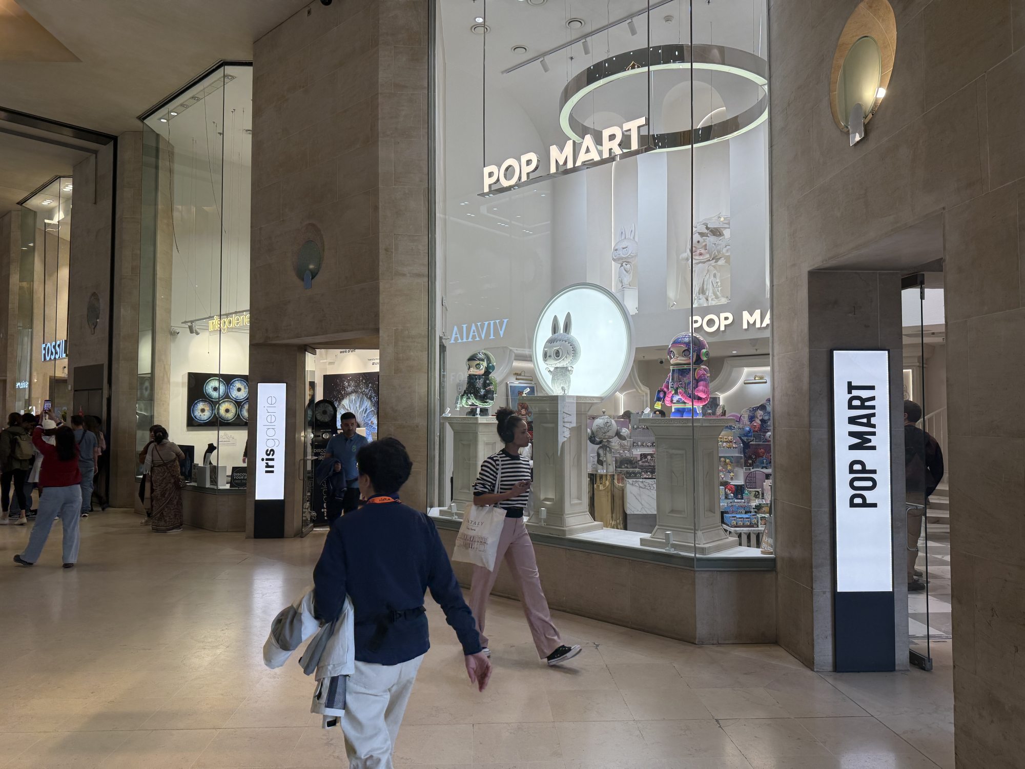 Shoppers walk past the window of a Pop Mart store near the Louvre Museum in Paris. The Chinese toy giant has attracted a devoted fan base in Europe with its Labubu and Crybaby collectible dolls. Photo: Xiaofei Xu Shoppers walk past the window of a Pop Mart store near the Louvre Museum in Paris. The Chinese toy giant has attracted a devoted fan base in Europe with its Labubu and Crybaby collectible dolls. Photo: Xiaofei Xu
