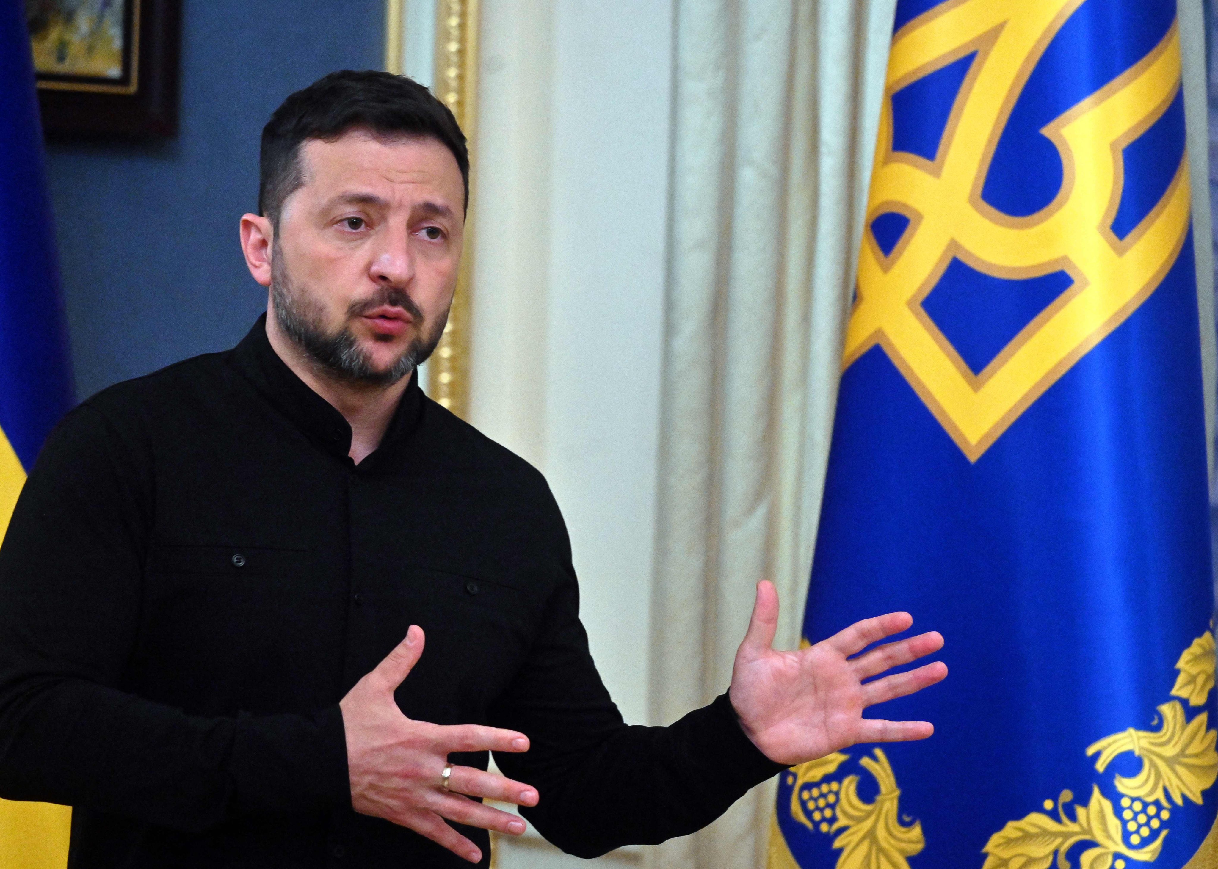 Ukraine’s President Volodymyr Zelensky speaks to the media during a press briefing after his phone call with the US president, in Kyiv, on Monday. Photo: AFP