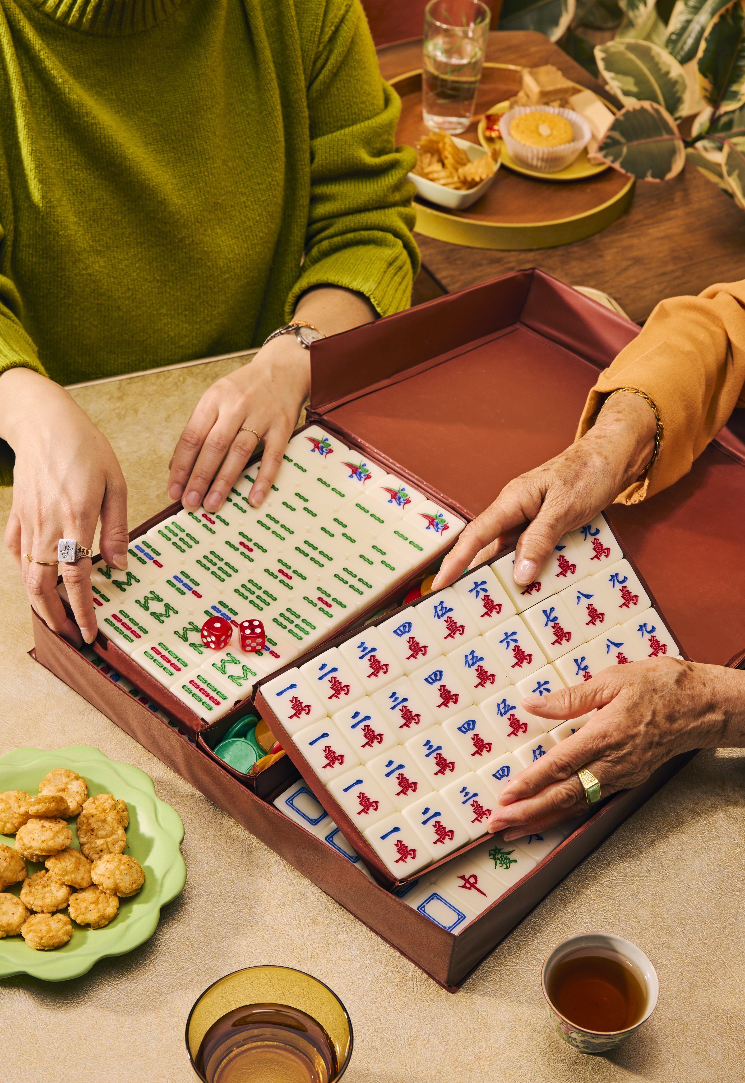 A photo from Nicole Wong’s book, Mahjong: House Rules from Across the Asian Diaspora. The photographs in the book feature personal props, as well as hands from multiple generations of Wong’s family. Photo: Andria Lo
