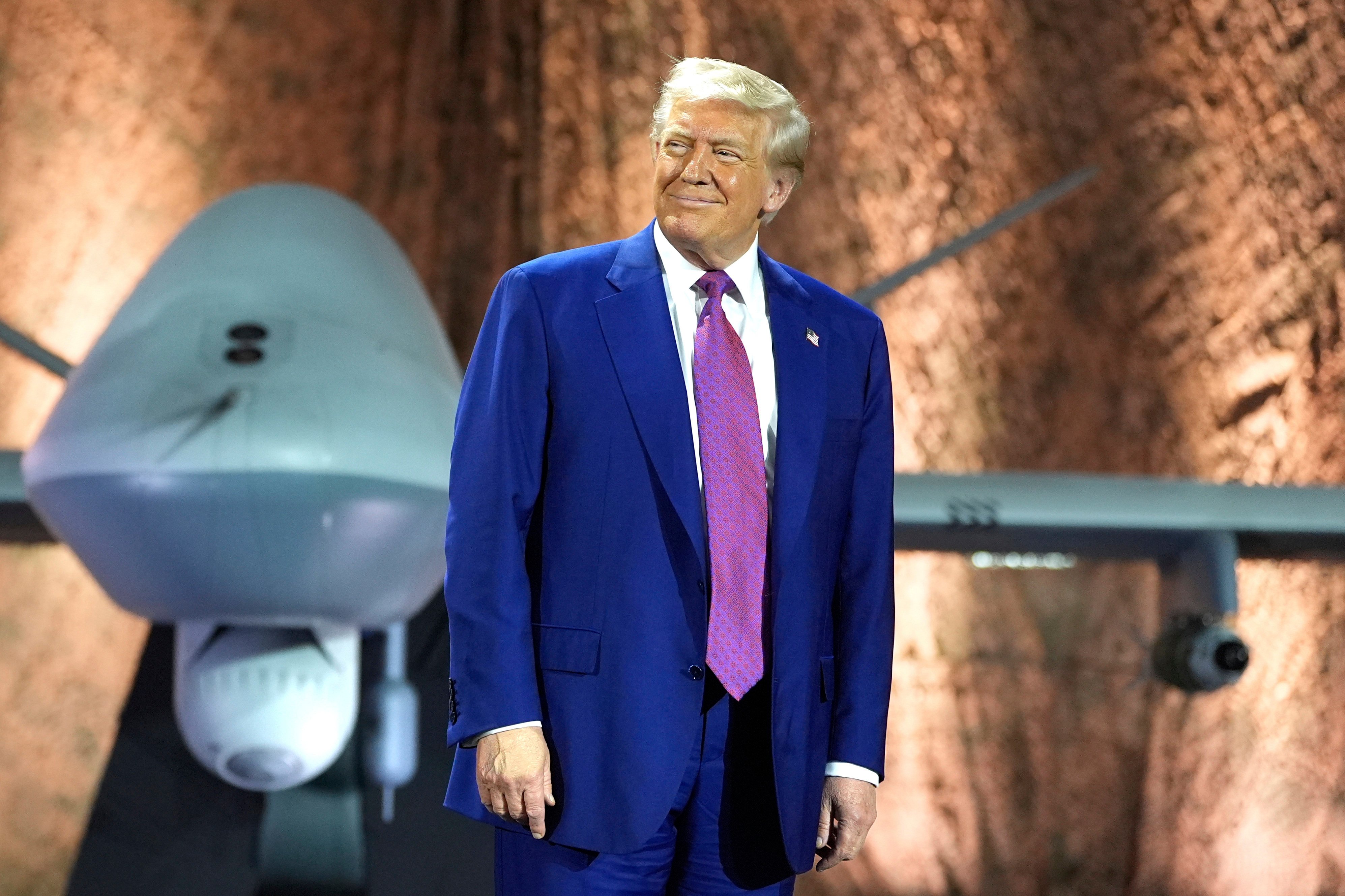 US President Donald Trump stands in front of an MQ-9 Reaper drone before addressing military personnel at Al Udeid Air Base in Qatar on Thursday. Photo: AP