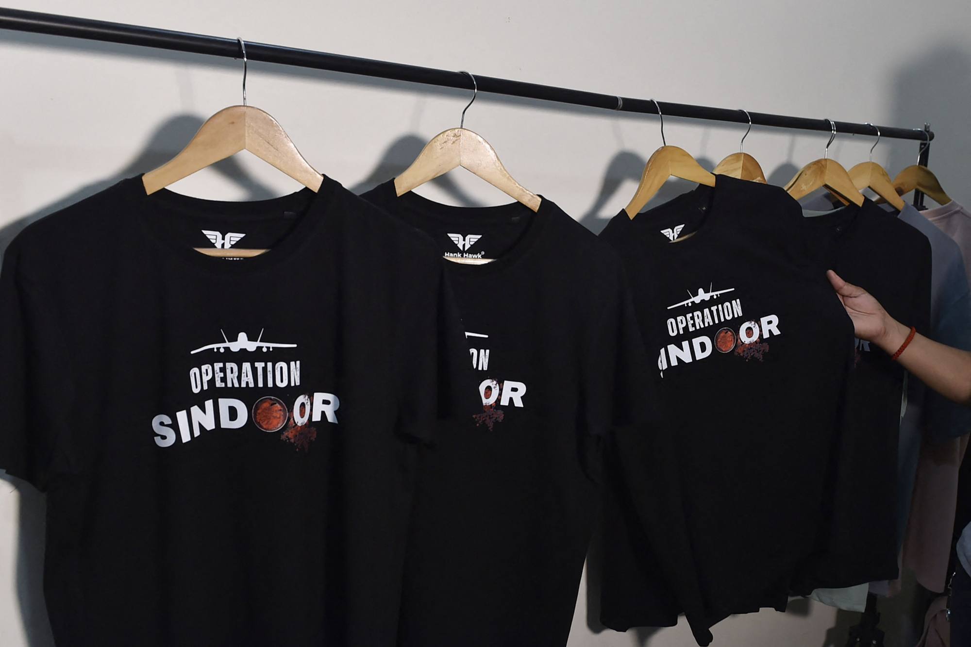 T-shirts featuring “Operation Sindoor” on display at a store in Ludhiana, India. Businesses have cashed in on the recent flare-up in the India-Pakistan conflict, offering military operation-themed T-shirts and tote bags. Photo: AFP T-shirts featuring “Operation Sindoor” on display at a store in Ludhiana, India. Businesses have cashed in on the recent flare-up in the India-Pakistan conflict, offering military operation-themed T-shirts and tote bags. Photo: AFP