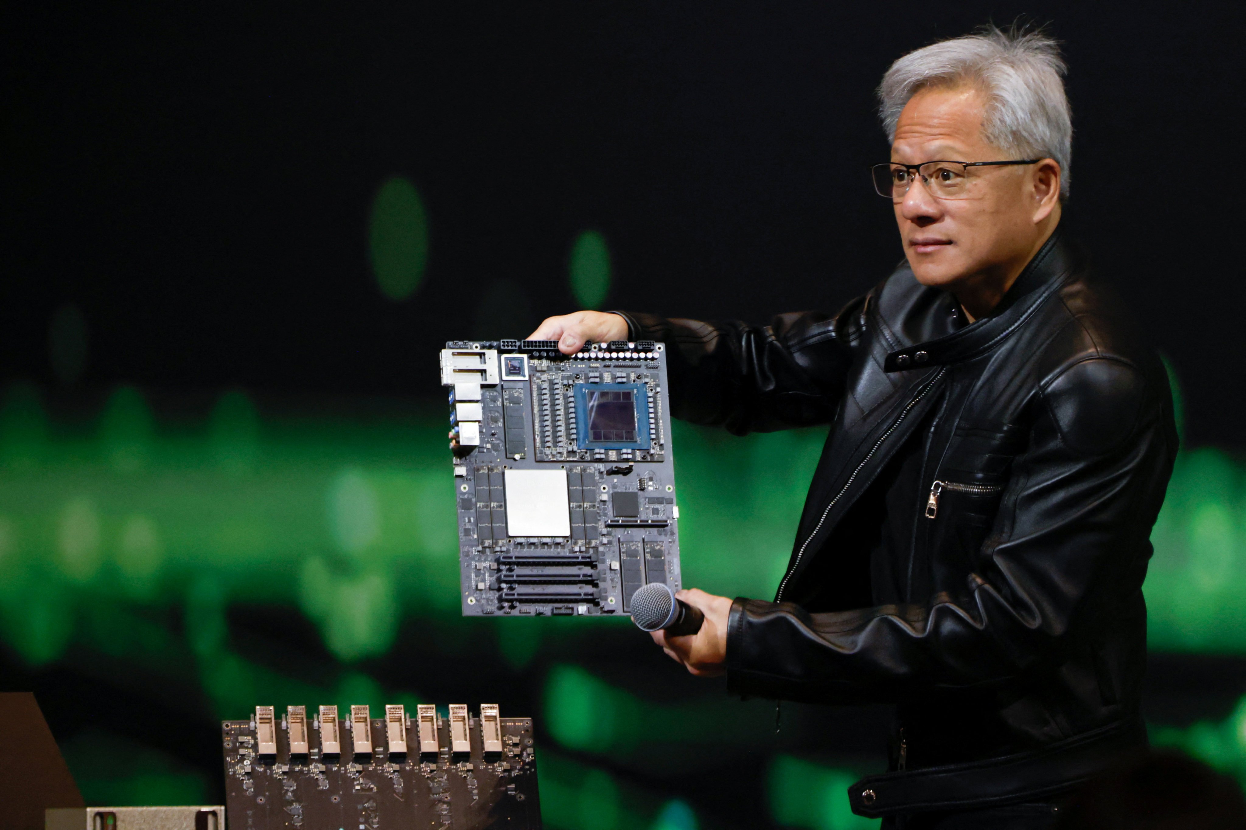 Nvidia CEO Jensen Huang holds a circuit board as he answers questions from members of the media at a press event in Taipei on May 21. Photo: Reuters