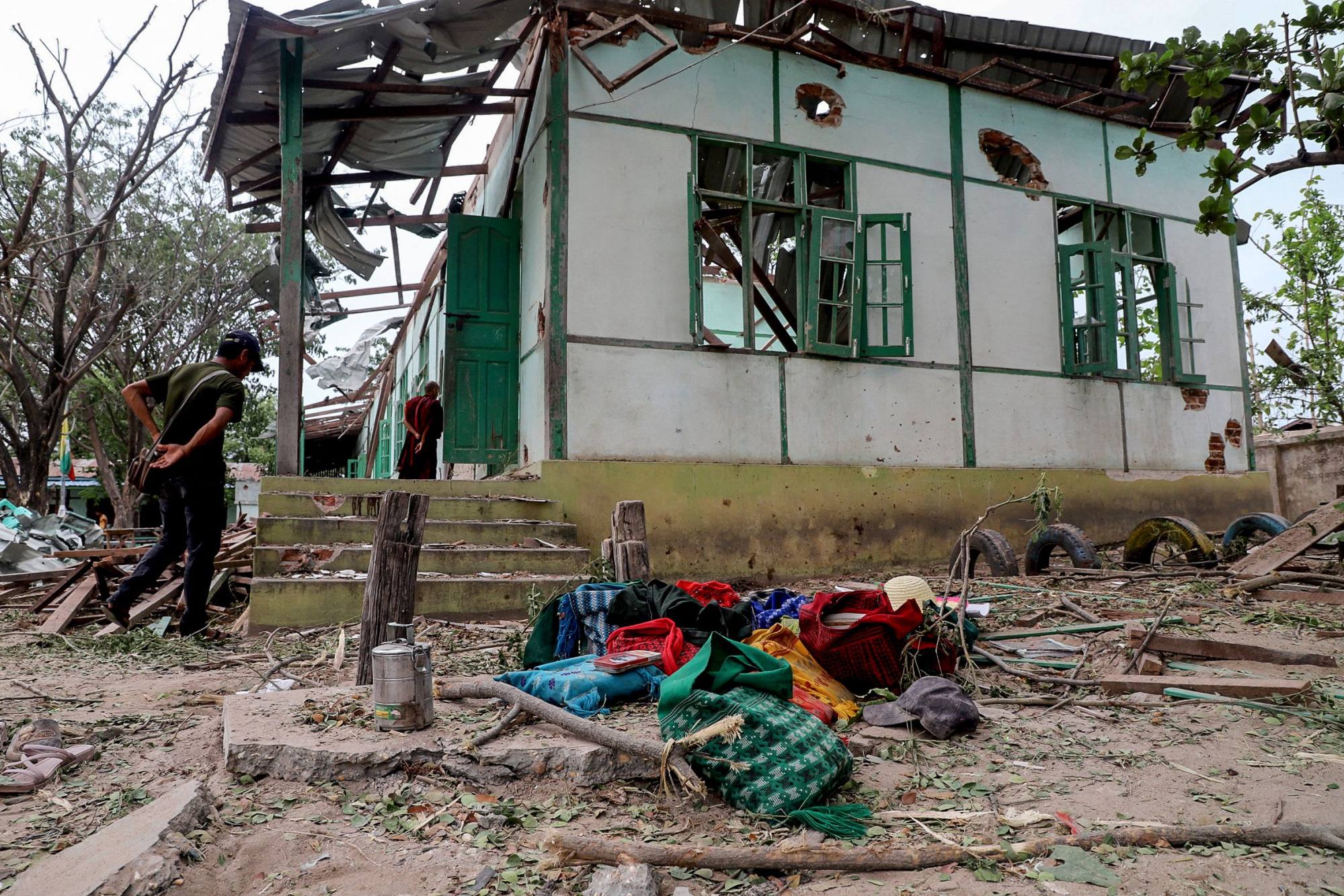 People gather near a school building damaged in a bombardment carried out by Myanmar’s military in Tabayin township, Sagaing region, on May 12. Photo: AFP People gather near a school building damaged in a bombardment carried out by Myanmar’s military in Tabayin township, Sagaing region, on May 12. Photo: AFP