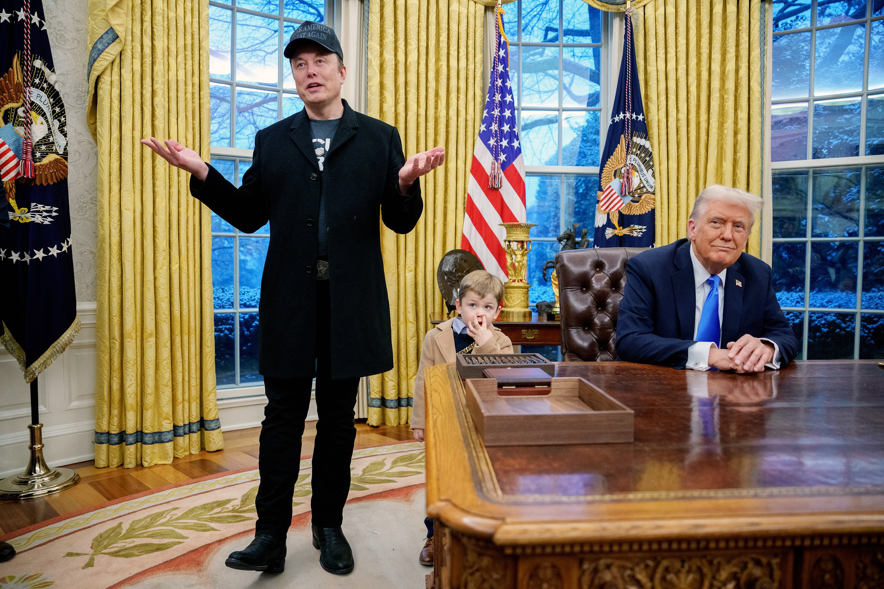 Elon Musk (left) accompanied by US President Donald Trump and his son X Musk, speaks in the Oval Office. Photo: TNS