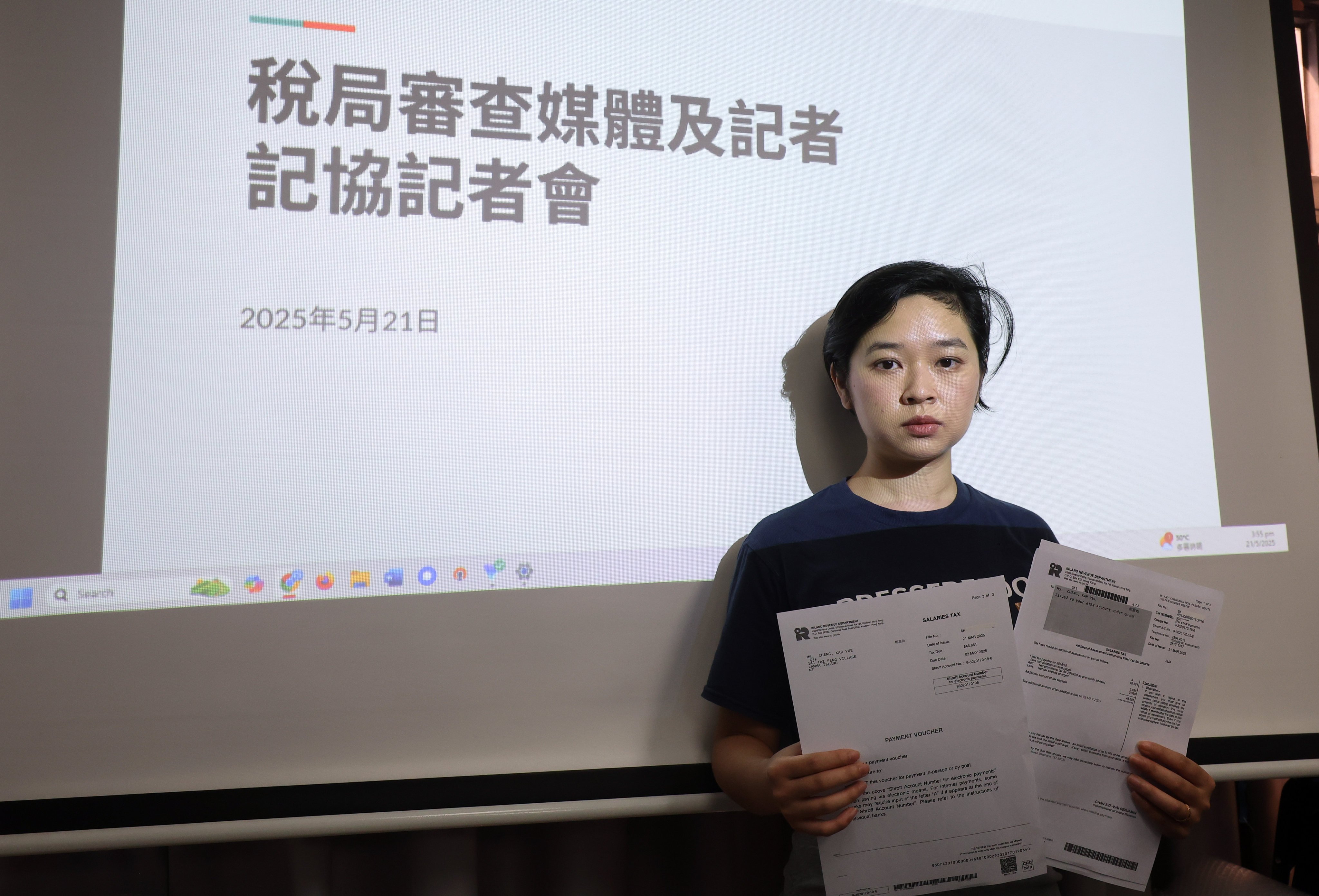 Hong Kong Journalists Association chairwoman Selina Cheng holds up a tax demand. Photo: Edmond So