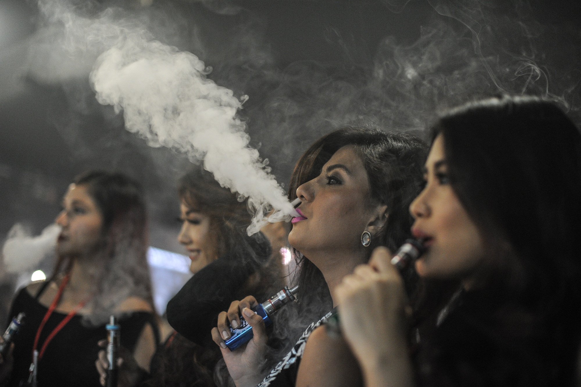 Promoters use vapes at an event in Kuala Lumpur in 2015. Mushroom-flavoured vapes containing psychoactive substances are a growing concern in Malaysia. Photo: AFP Promoters use vapes at an event in Kuala Lumpur in 2015. Mushroom-flavoured vapes containing psychoactive substances are a growing concern in Malaysia. Photo: AFP