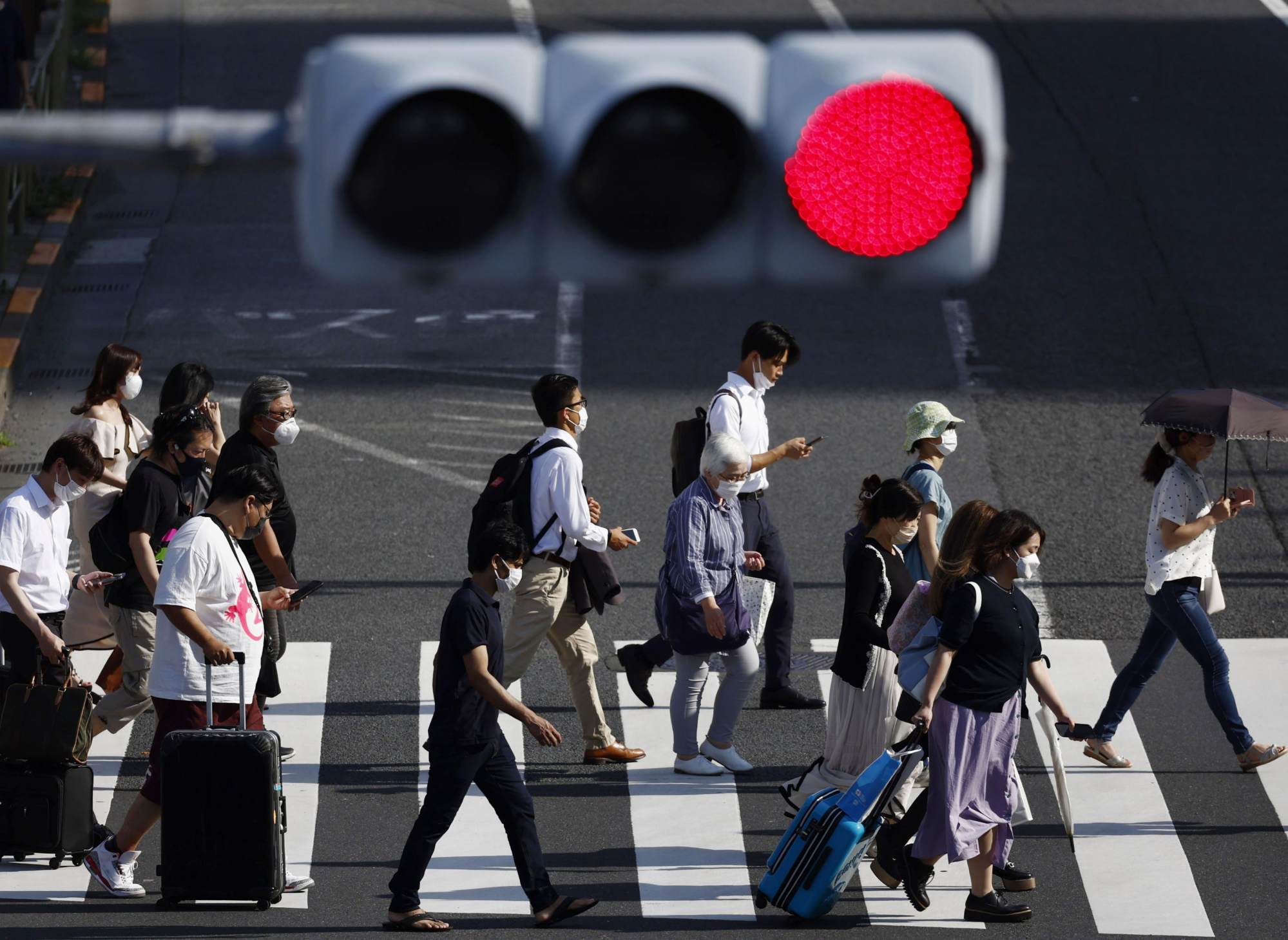 People at a pedestrian crossing in Tokyo. Japan could put in place new regulations to boost road safety in the wake of high-profile accidents involving foreign drivers. Photo: Kyodo People at a pedestrian crossing in Tokyo. Japan could put in place new regulations to boost road safety in the wake of high-profile accidents involving foreign drivers. Photo: Kyodo