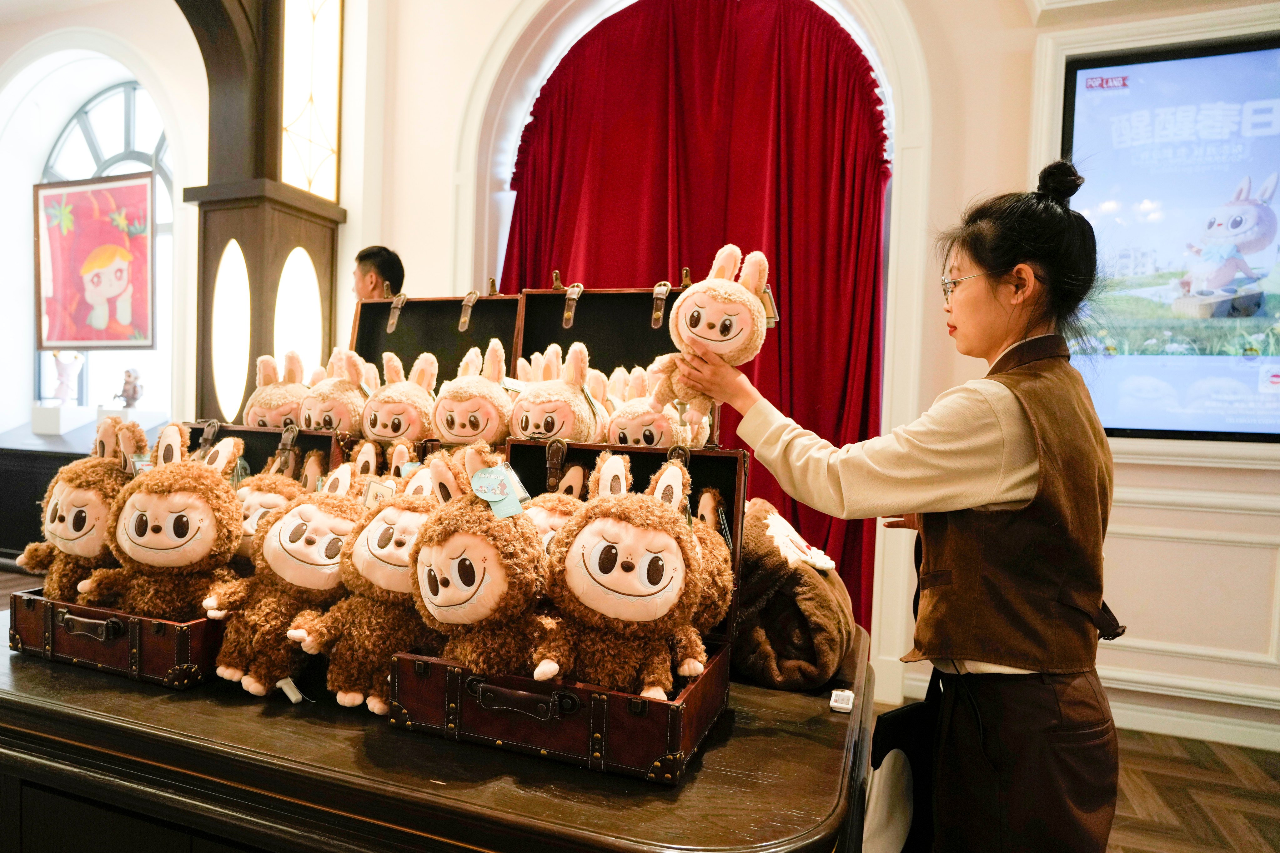 A worker stocks Labubu dolls at Pop Land, a theme park for Pop Mart in Beijing, on May 1, 2025. Photo: AP