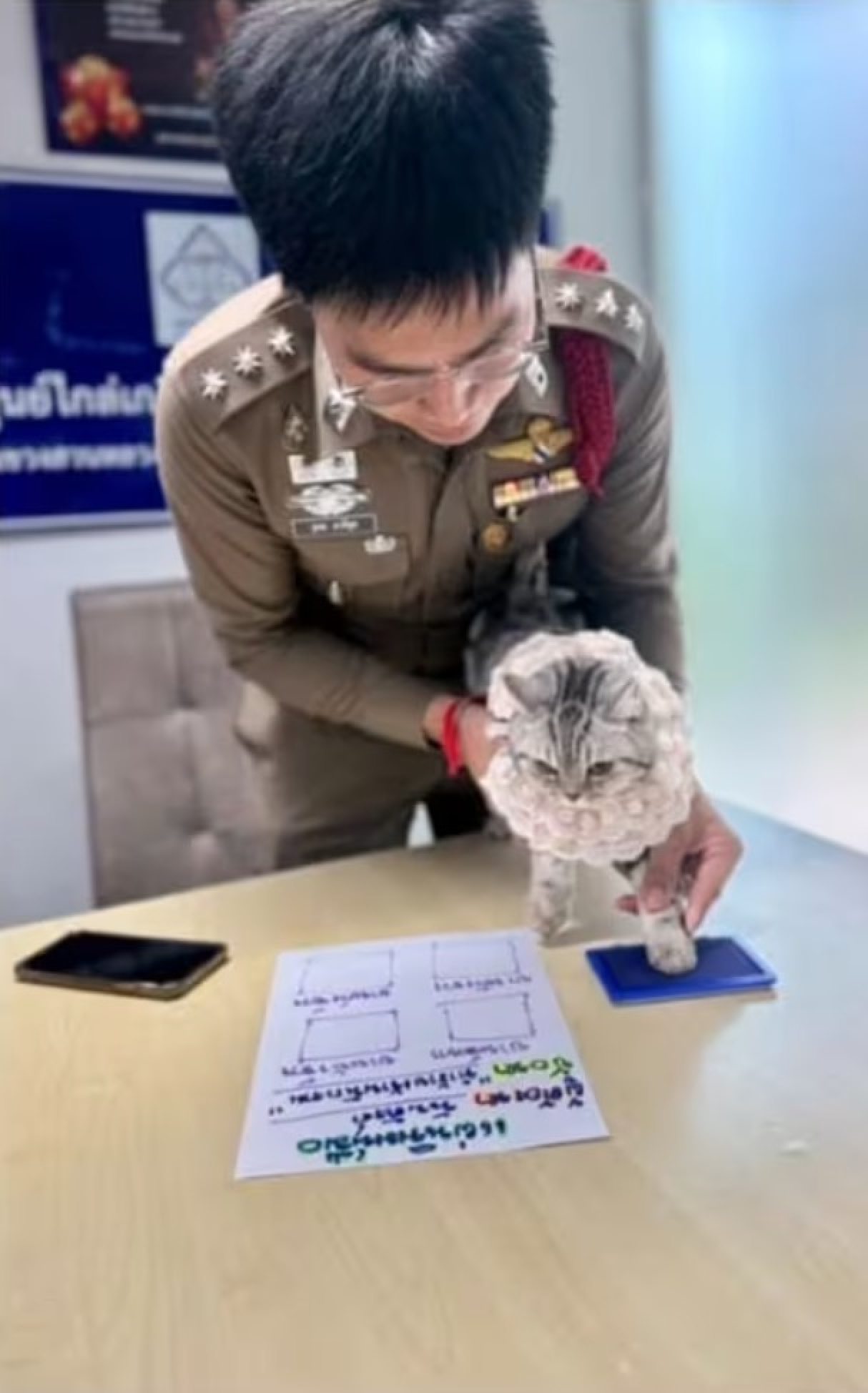 Before releasing the cat, an officer followed protocol by recording the paw prints of the little “suspect,” adding a touch of humour to the situation. Photo: Parinda Yukol Pakeesuk/Facebook Before releasing the cat, an officer followed protocol by recording the paw prints of the little “suspect,” adding a touch of humour to the situation. Photo: Parinda Yukol Pakeesuk/Facebook