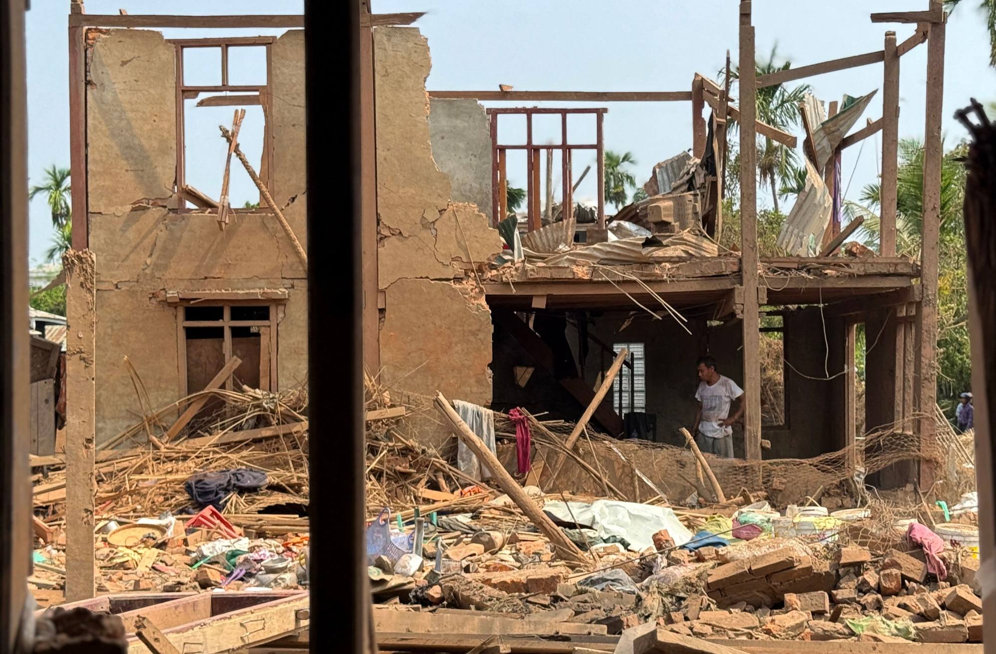 People assess the damage following military air strikes in Kyauktaw town in Myanmar on May 15. Photo: AFP People assess the damage following military air strikes in Kyauktaw town in Myanmar on May 15. Photo: AFP