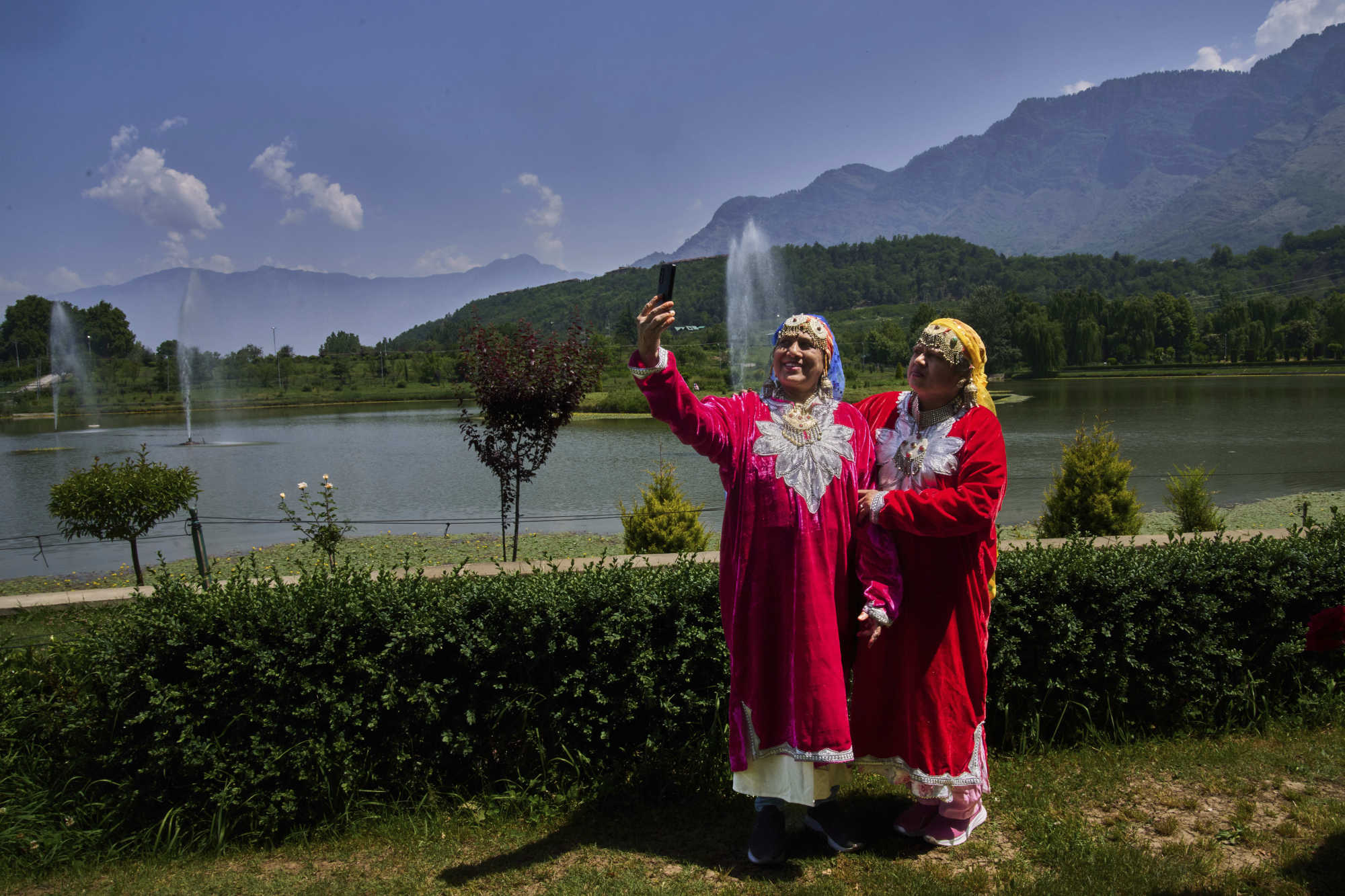 Tourists take a selfie inside a deserted garden in Srinagar. Photo: AP Tourists take a selfie inside a deserted garden in Srinagar. Photo: AP
