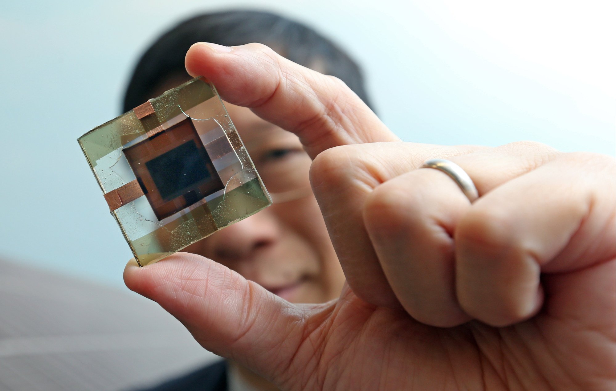 Professor Charles Chee Surya holds perovskite-silicon tandem solar cells. Perovskites have photovoltaic properties, allowing them to convert light into voltage. Photo: K. Y. Cheng Professor Charles Chee Surya holds perovskite-silicon tandem solar cells. Perovskites have photovoltaic properties, allowing them to convert light into voltage. Photo: K. Y. Cheng