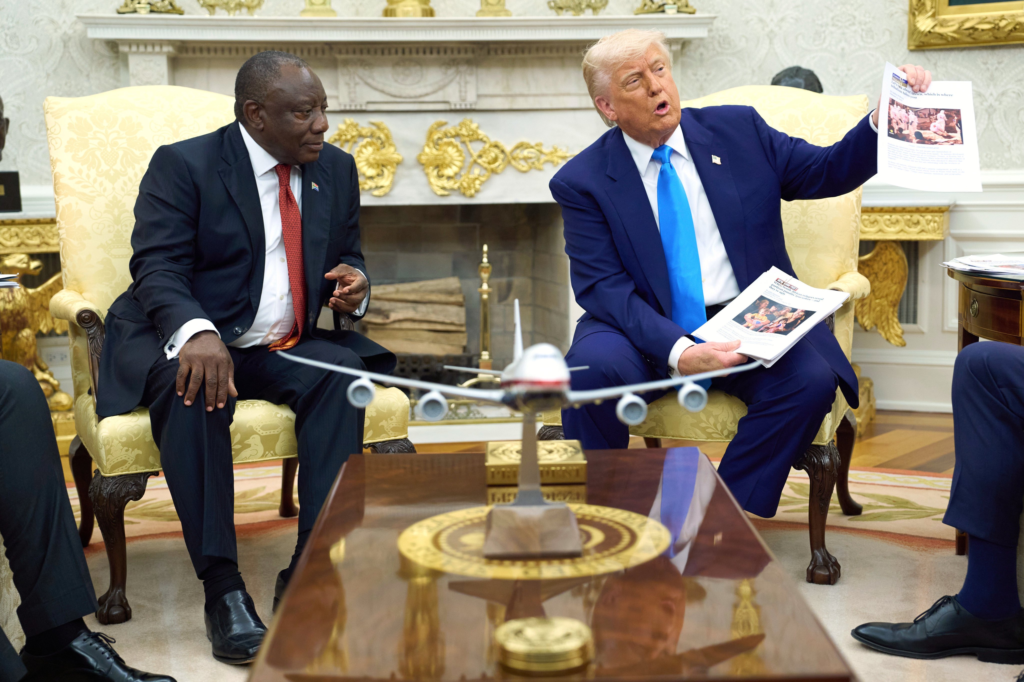 US President Donald Trump shows pictures and articles as he meets with South African President Cyril Ramaphosa. Photo: AP