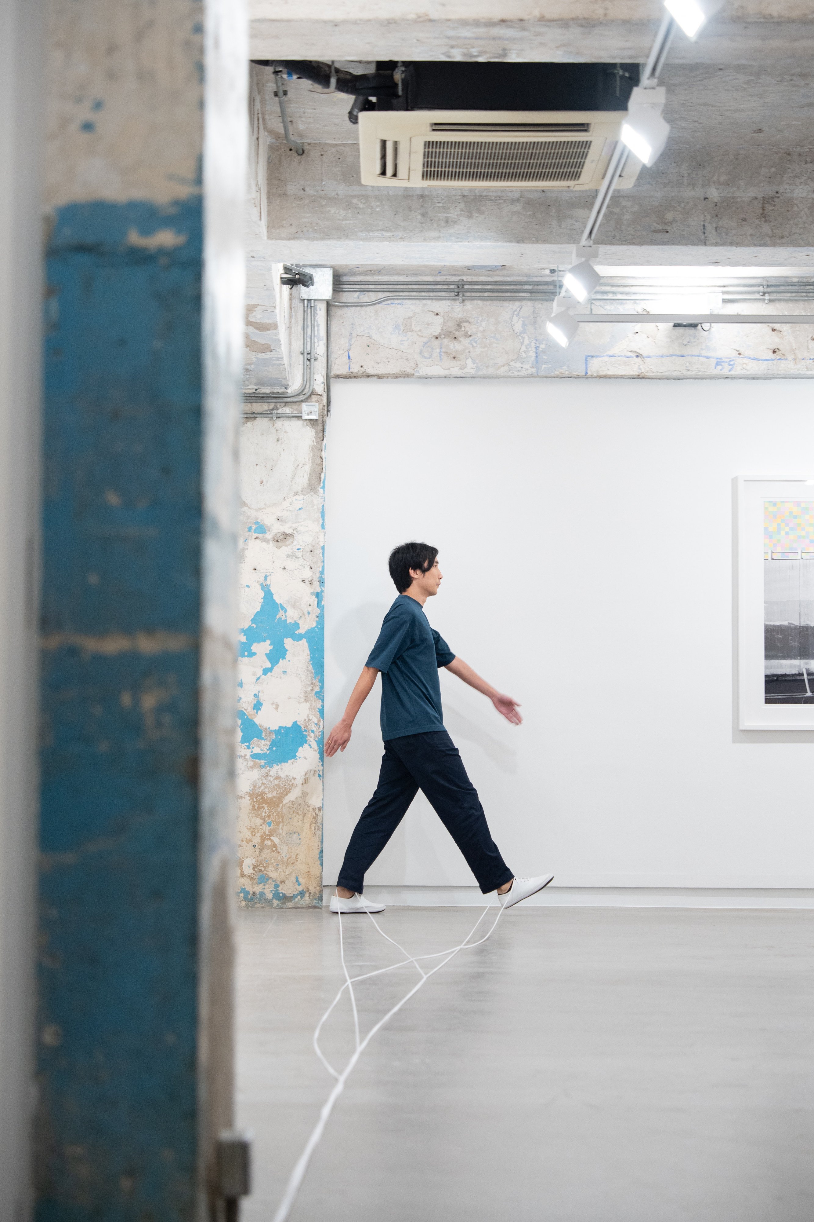 South Ho Siu-nam’s “Me, My White Sneakers, and Shoelaces” (2025) durational performance at Blindspot Gallery. Photo: courtesy artist and Blindspot Gallery
