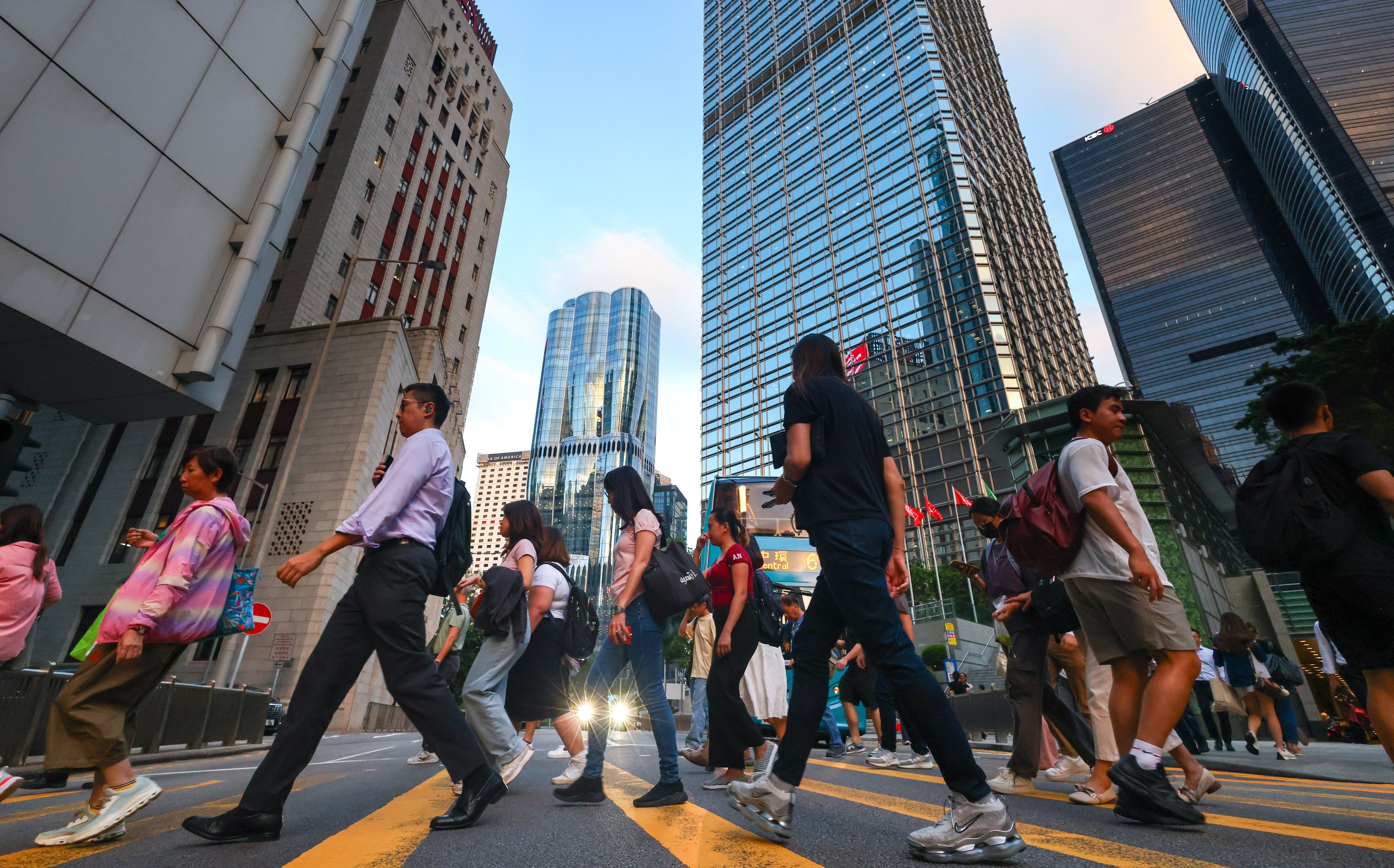 Commuters cross Queen’s Road Central in Hong Kong’s Central district in October last year. AI advancements present opportunities for increased efficiency, but also risks of job displacement, and there is a need to upskill workers so they can keep up. Photo: Dickson Lee
