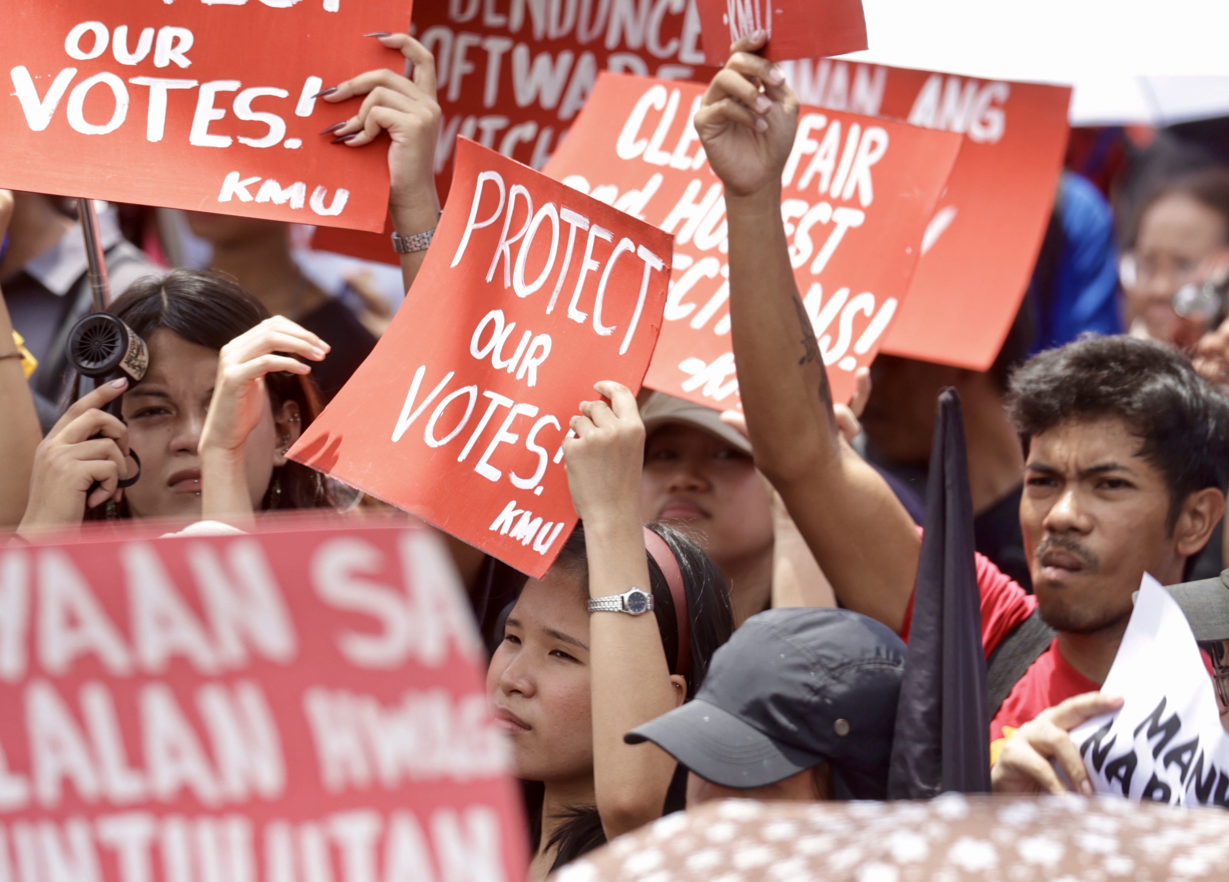Protesters gestures and hold placards during a demonstration against electoral fraud on the first day of canvassing of votes outside the Commission on Elections (Comelec) office in Manila, Philippines, on May 13. Photo: EPA-EFE
