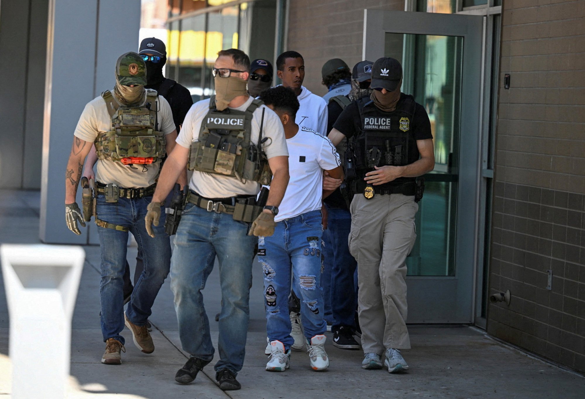 Law enforcement officers, including agents from Homeland Security Investigations (HSI) and Immigration and Customs Enforcement (ICE), take people into custody at an immigration court in Phoenix, Arizona, on Wednesday. Photo: Reuters Law enforcement officers, including agents from Homeland Security Investigations (HSI) and Immigration and Customs Enforcement (ICE), take people into custody at an immigration court in Phoenix, Arizona, on Wednesday. Photo: Reuters